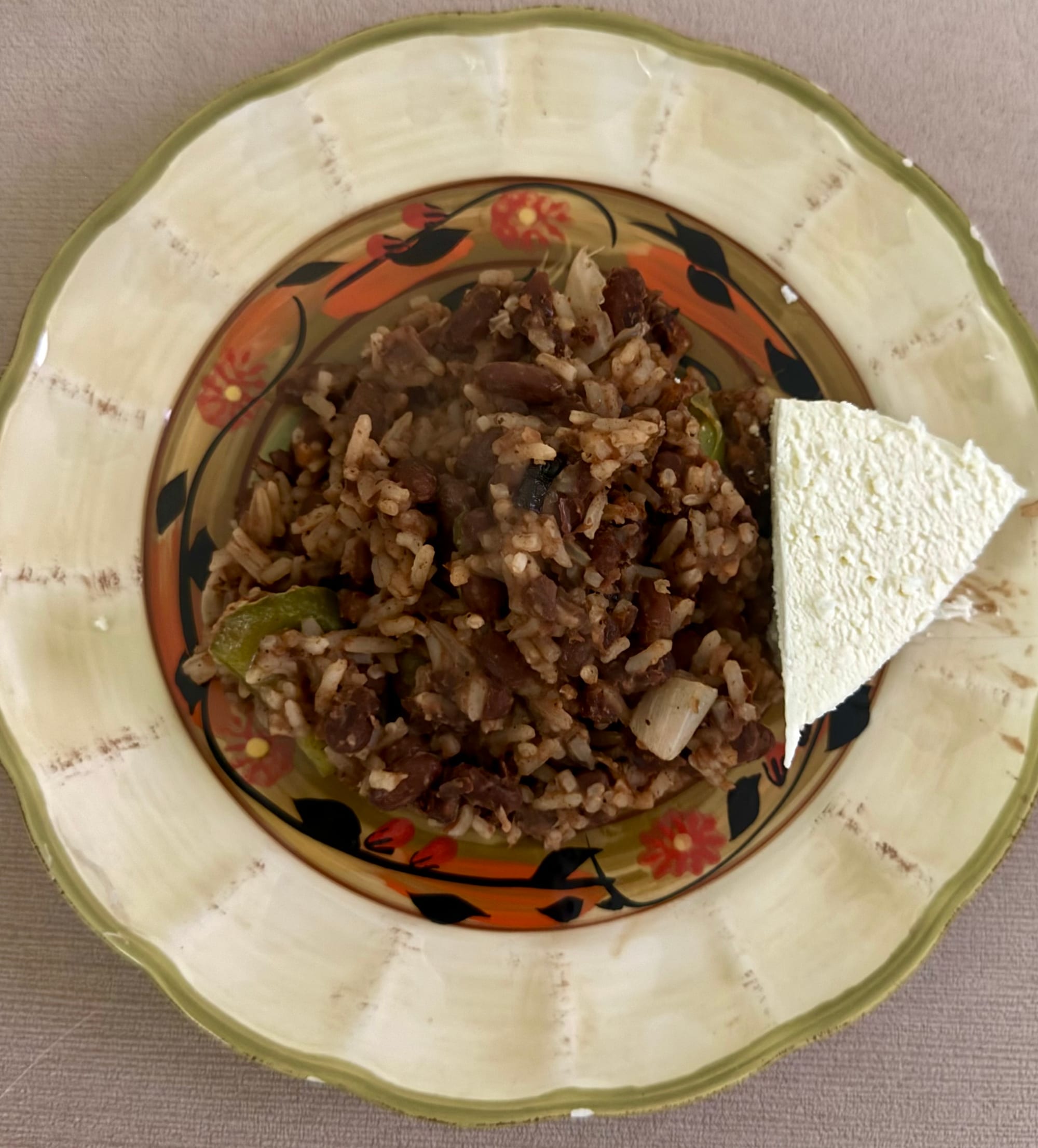 A plate of rice and beans fried together, giving a speckled appearance