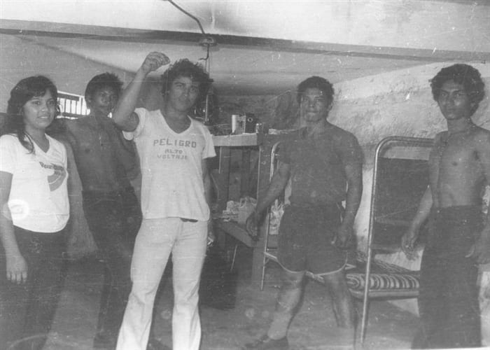 Armed Sandinista fighters and civilians celebrating in the streets of León in 1979