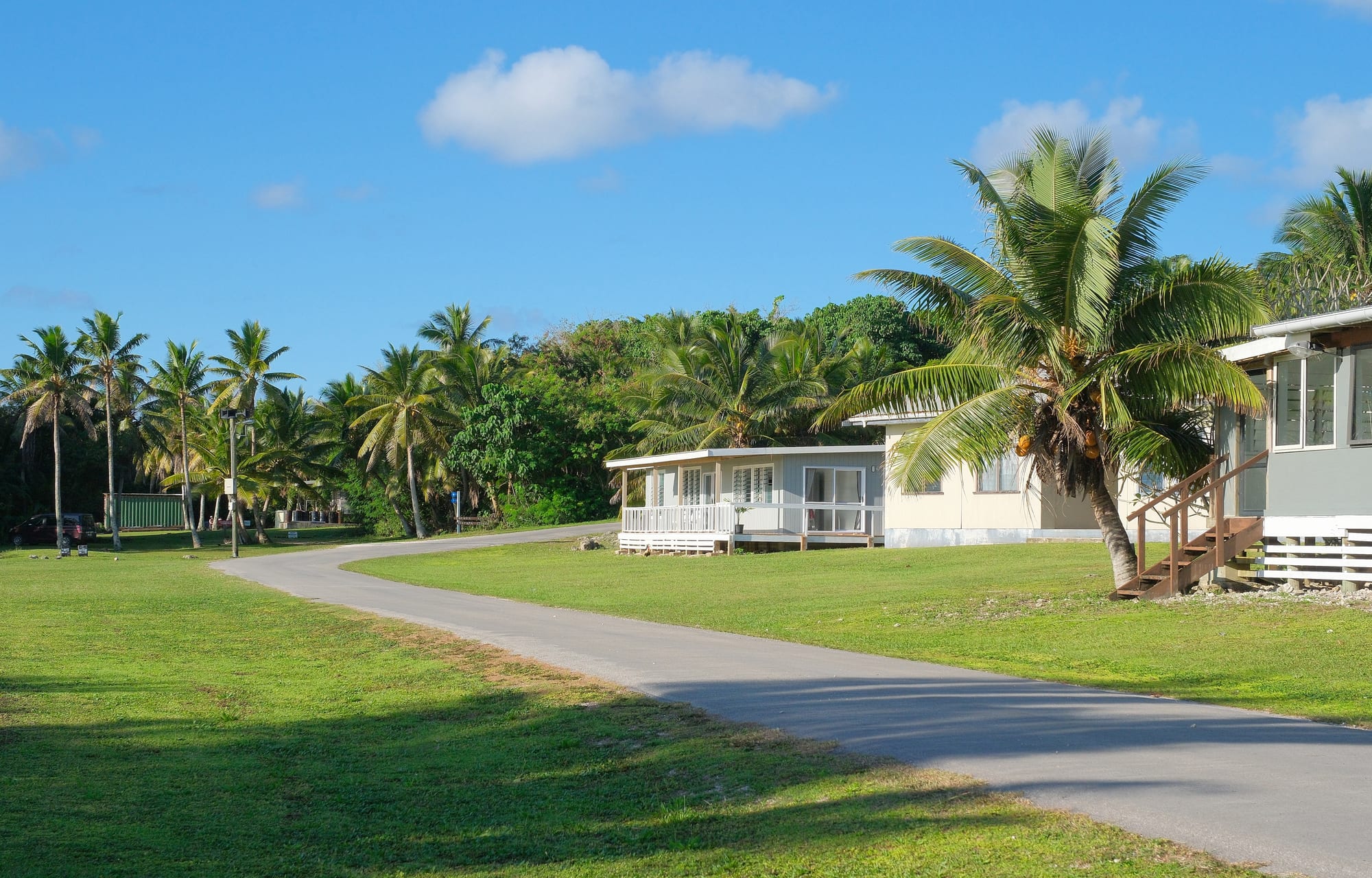 A small coastal village with modest houses among palm trees