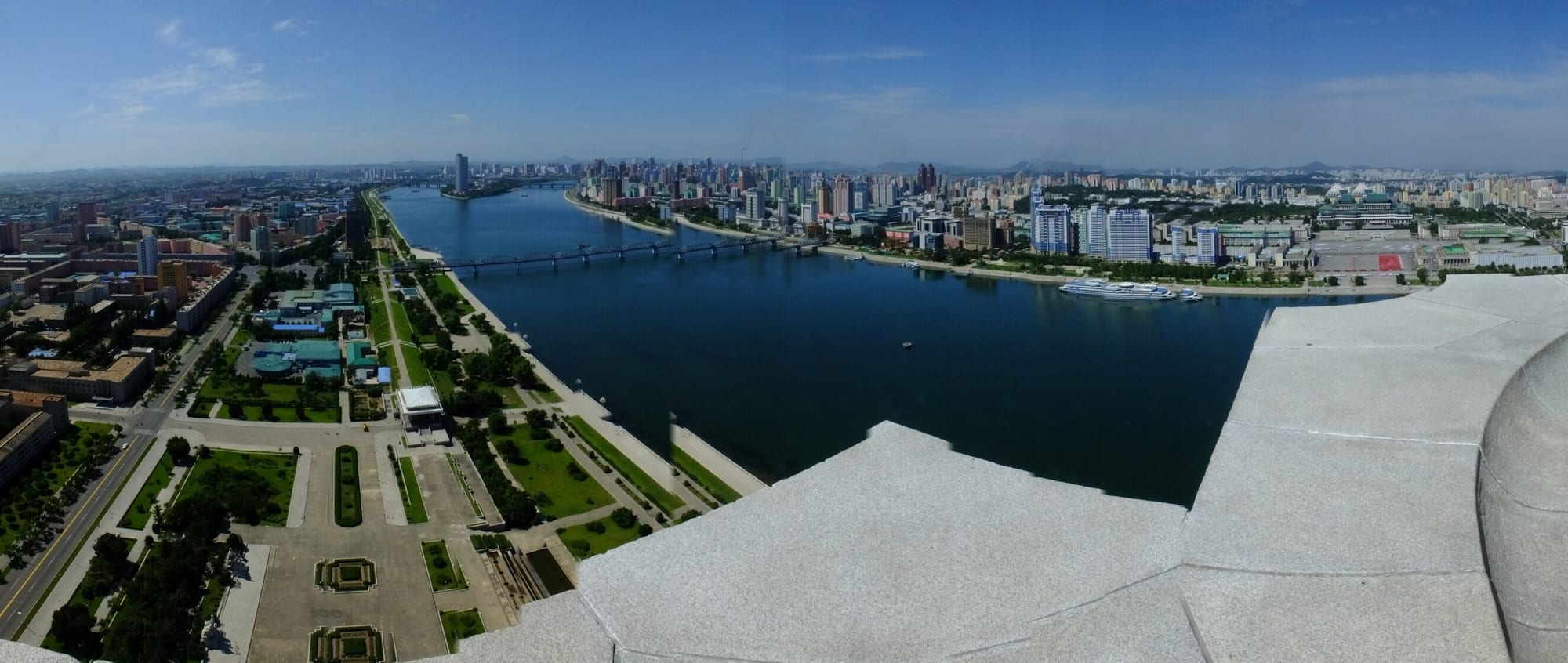 A panorama of Pyongyang's wide avenues, monuments and apartment blocks along the Taedong River