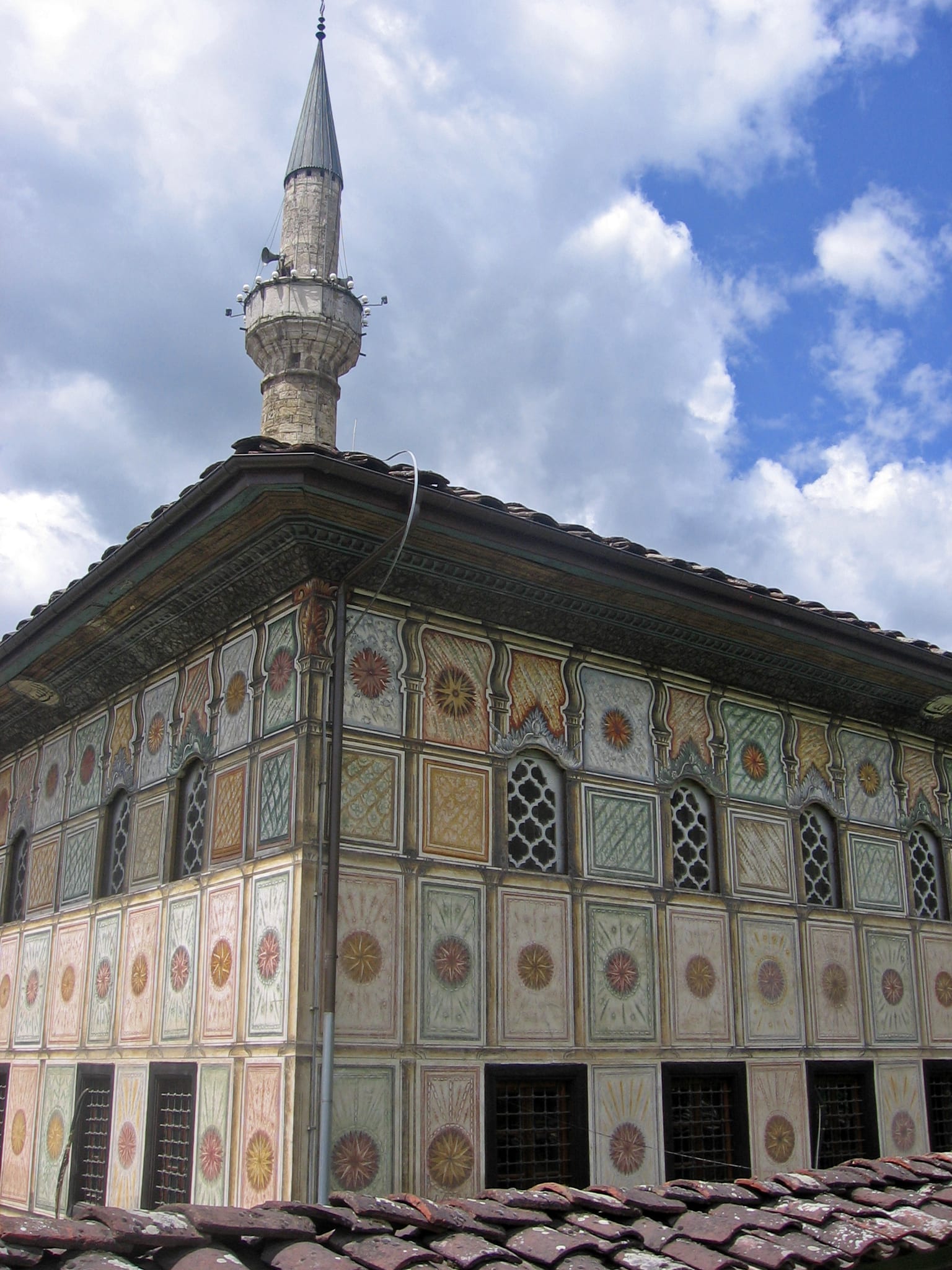 A small mosque covered entirely in colourful painted floral patterns