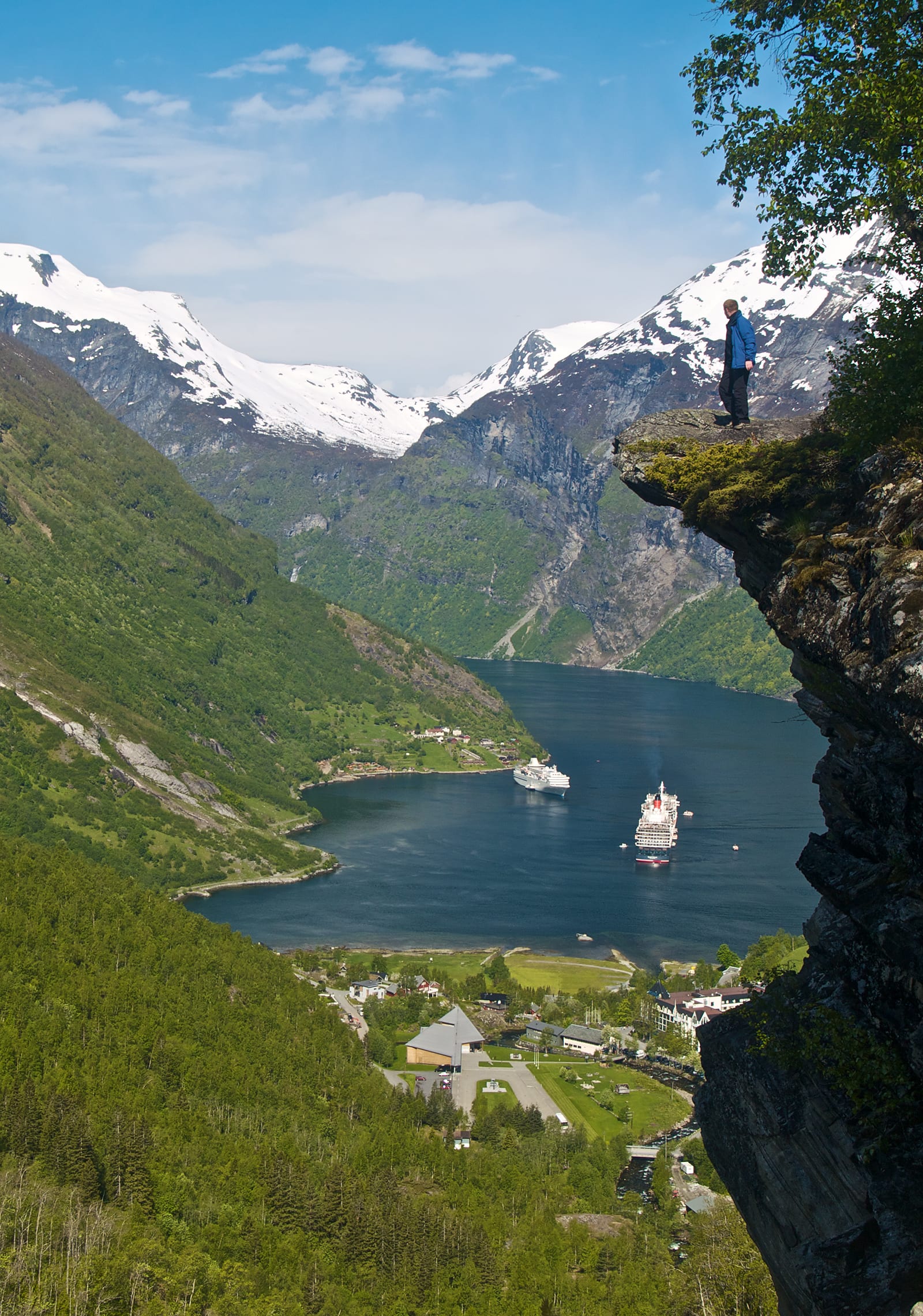 A narrow blue fjord winding between steep green mountains