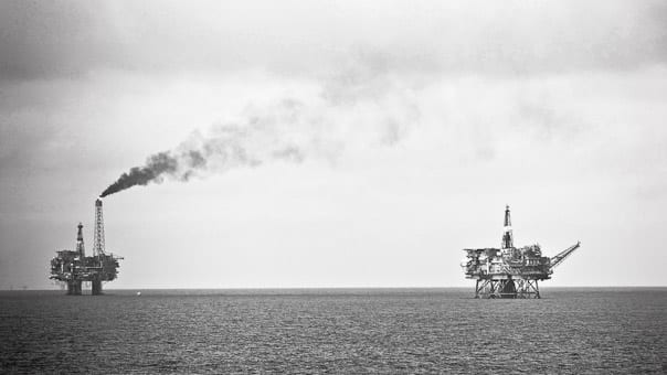 Offshore oil production platforms standing in a grey North Sea