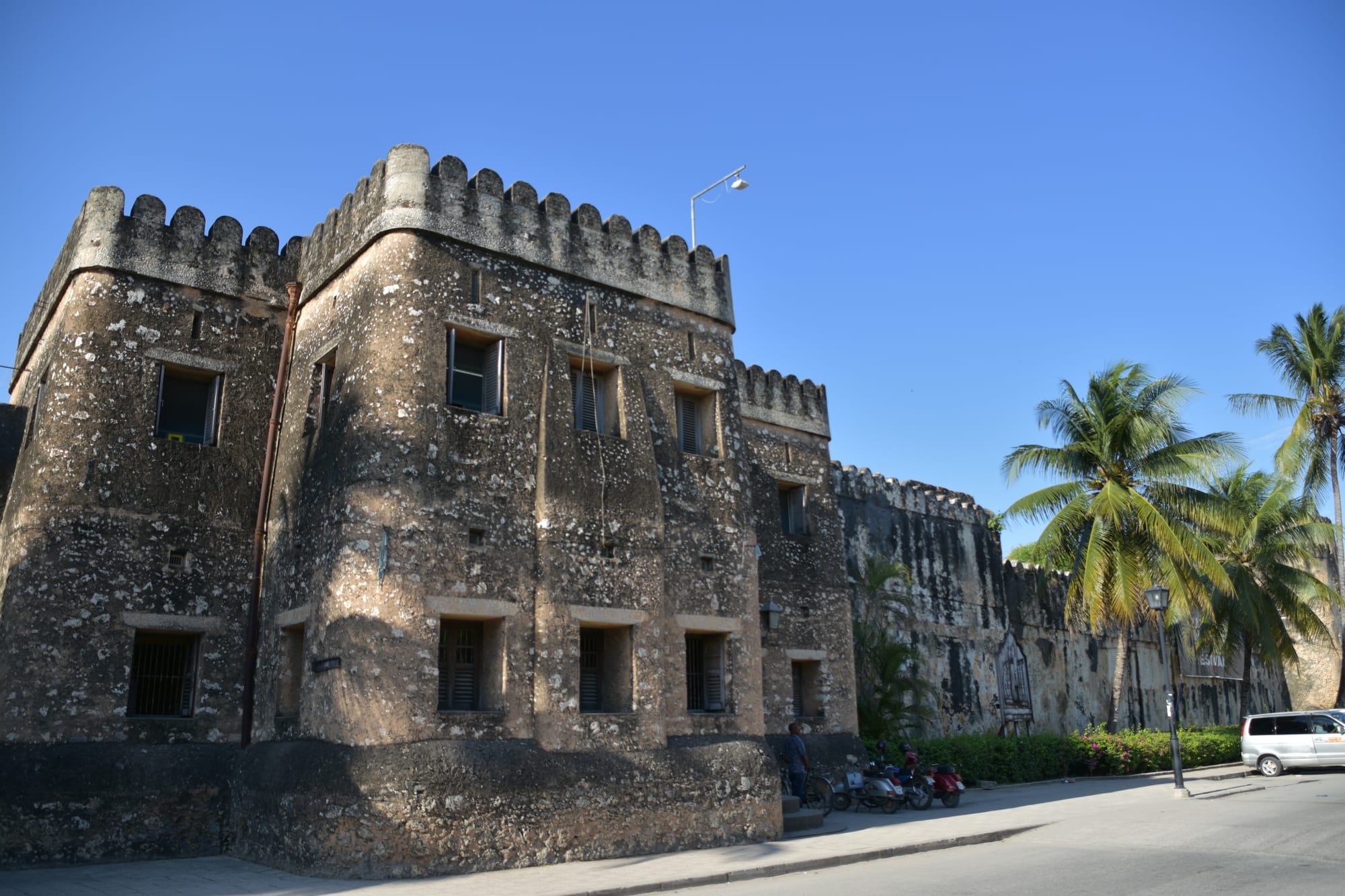 A large Omani stone fort with crenellated walls in Stone Town, Zanzibar