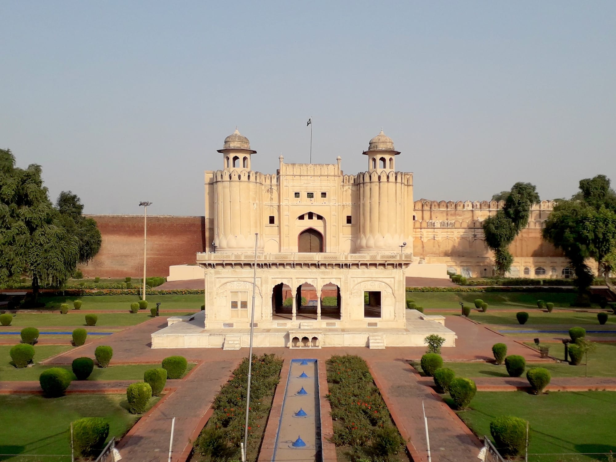 A large fortified palace complex with domes and gardens
