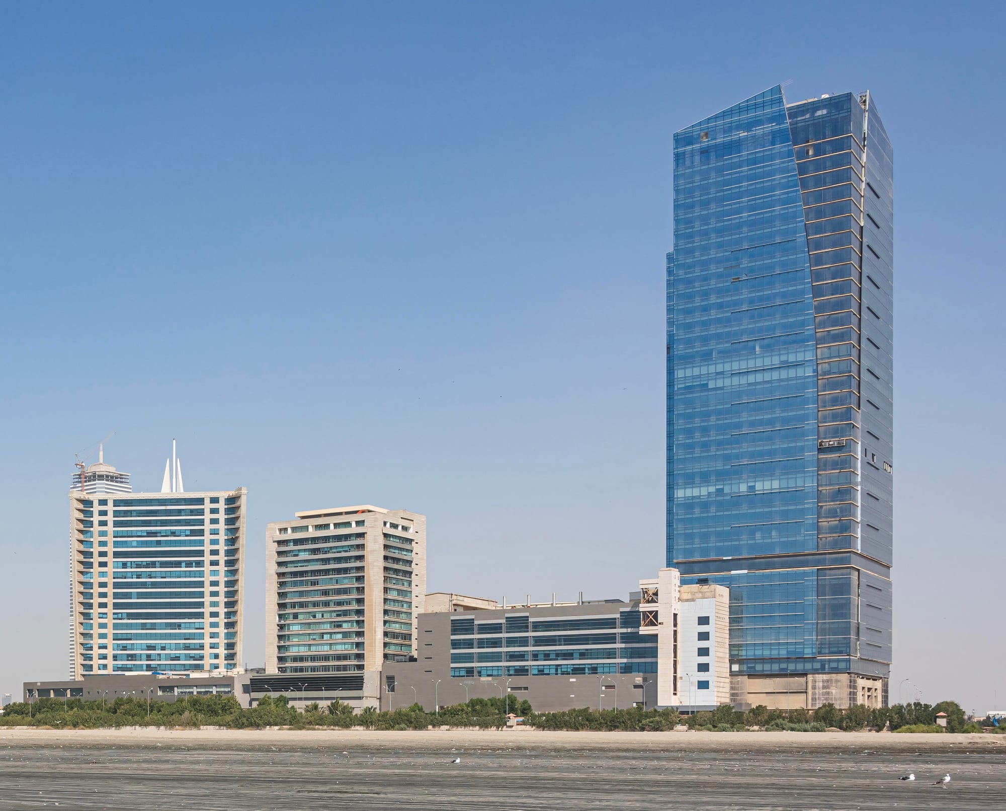 Modern glass high-rise towers along Karachi's Clifton beachfront