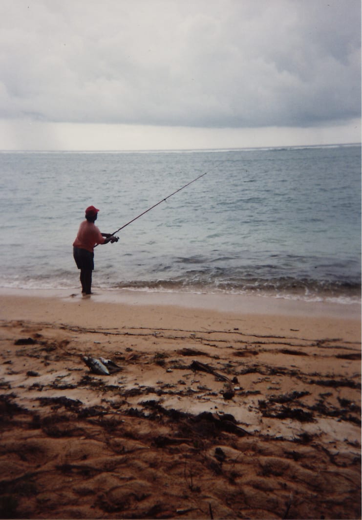 A man fishing from the shoreline in Palau