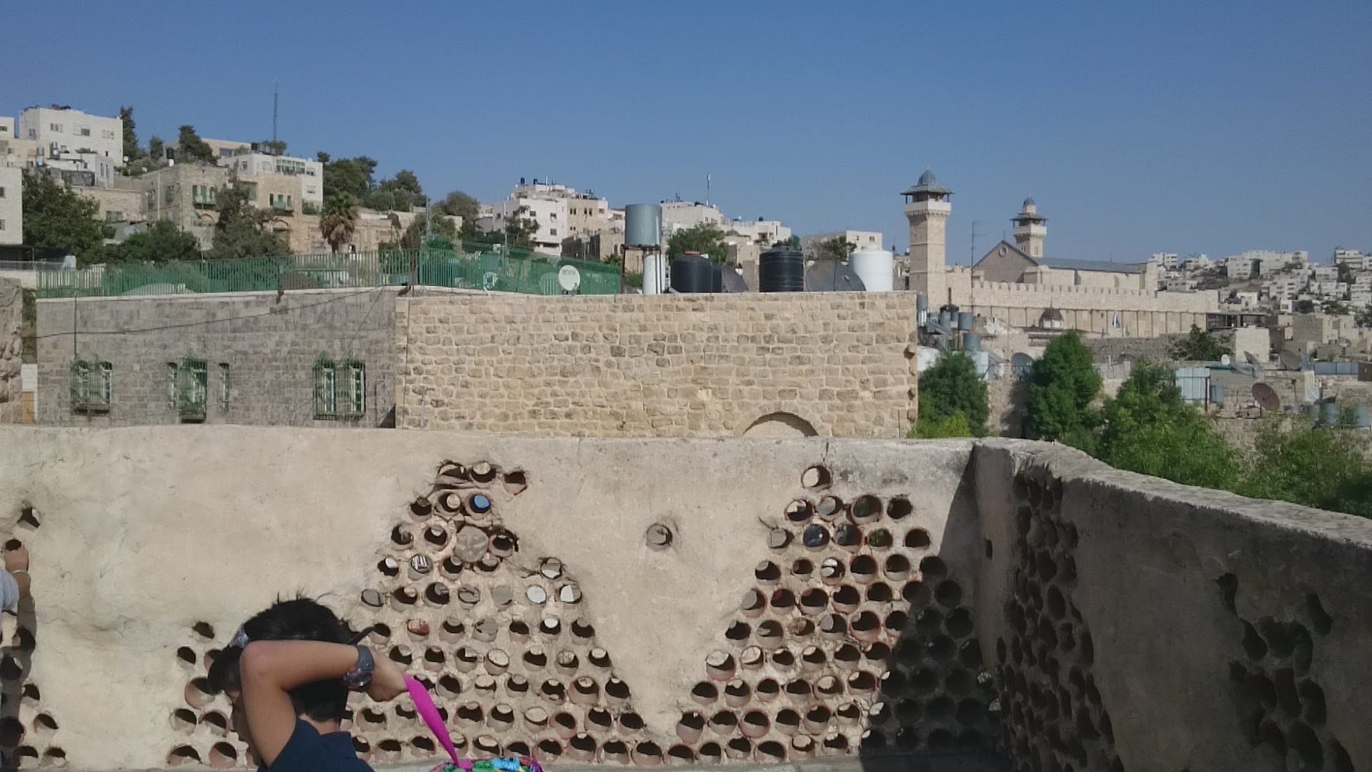 A large stone mosque and shrine complex with a tall square tower