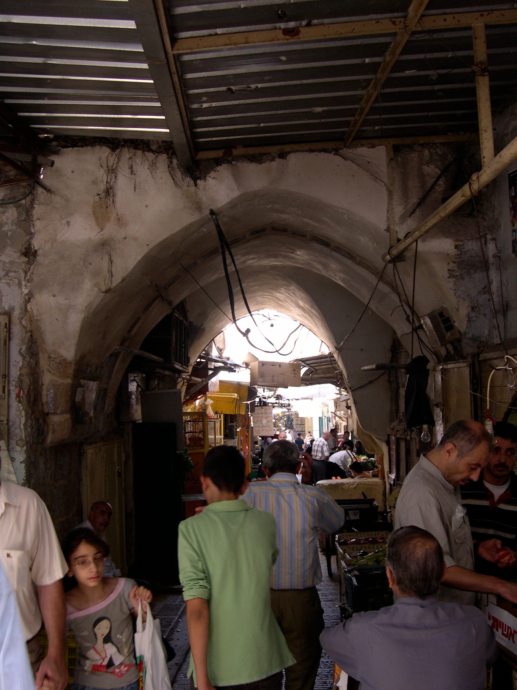 A narrow stone alleyway in an old Middle Eastern city market