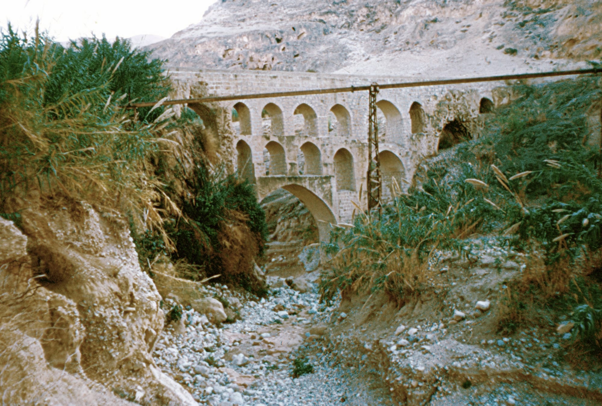 The remains of an ancient stone aqueduct in a desert landscape