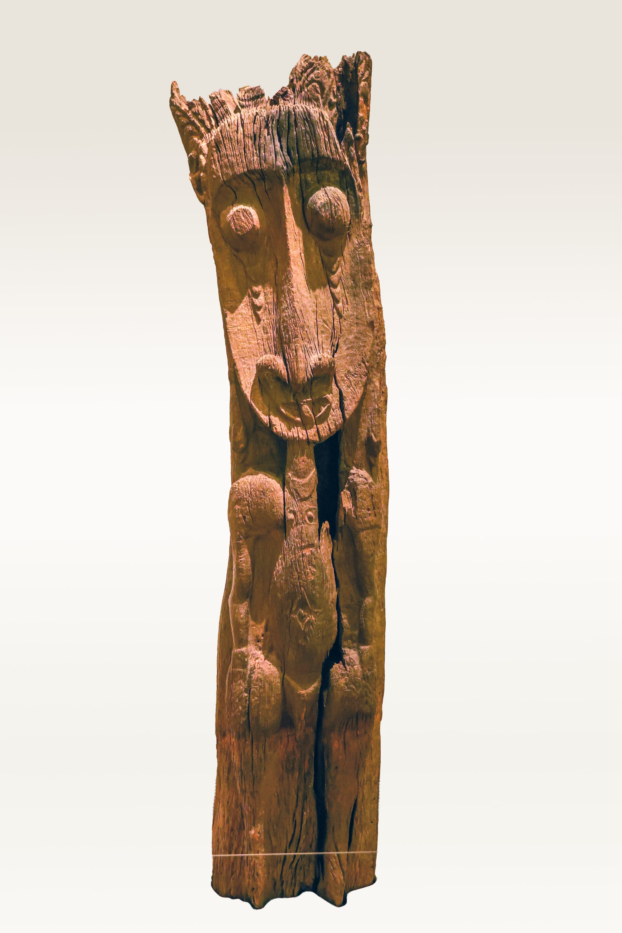 Tall carved and painted wooden posts inside an Iatmul men's ceremonial house on the Sepik River