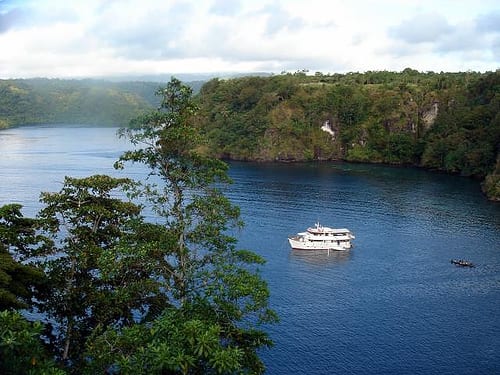 A narrow, calm fjord-like inlet surrounded by green rainforest