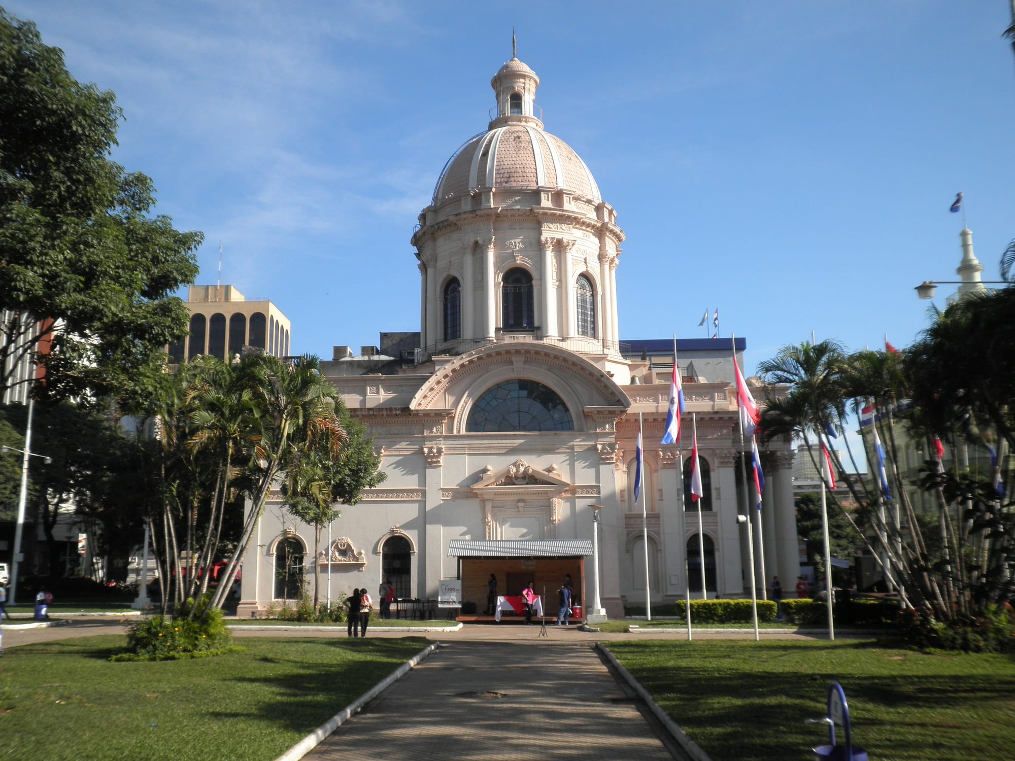 A domed white neoclassical building on a city street