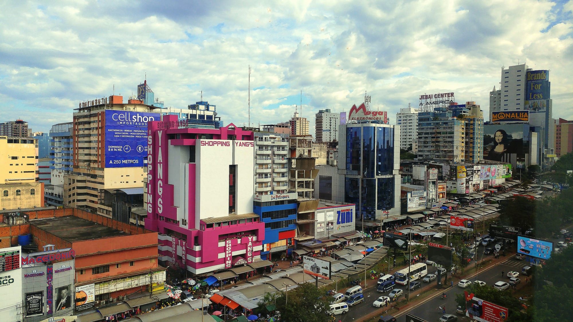 A busy commercial street lined with shops and signage
