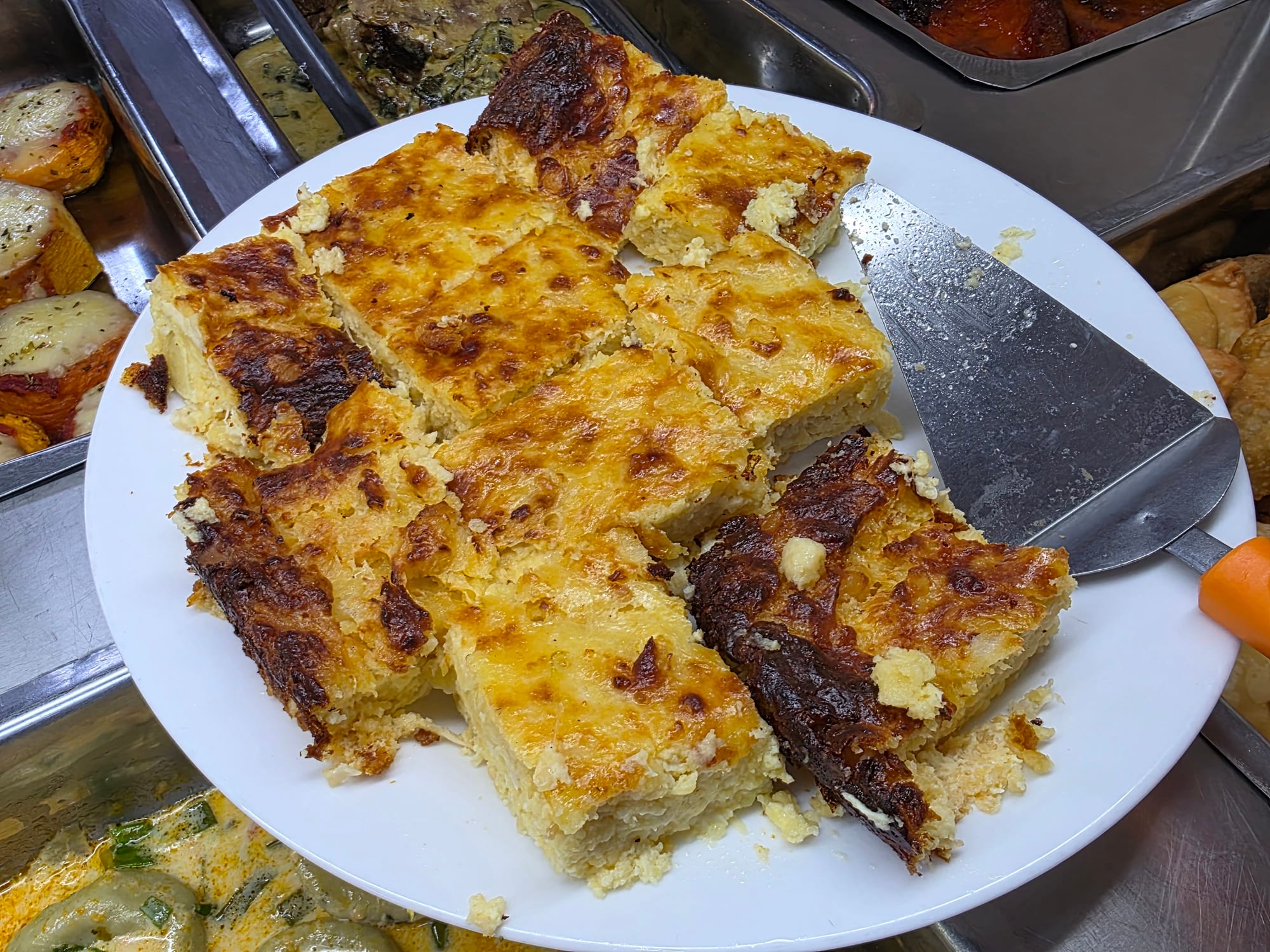 Square portions of golden-brown cornbread on a plate