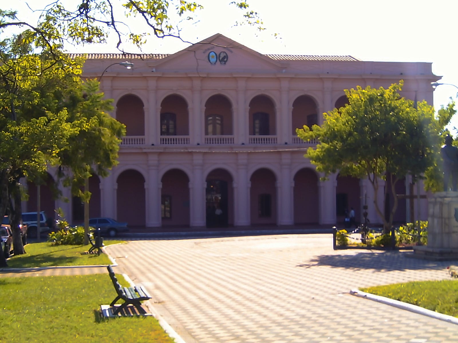 The white colonial Cabildo building in Asunción seen from the plaza with palm trees