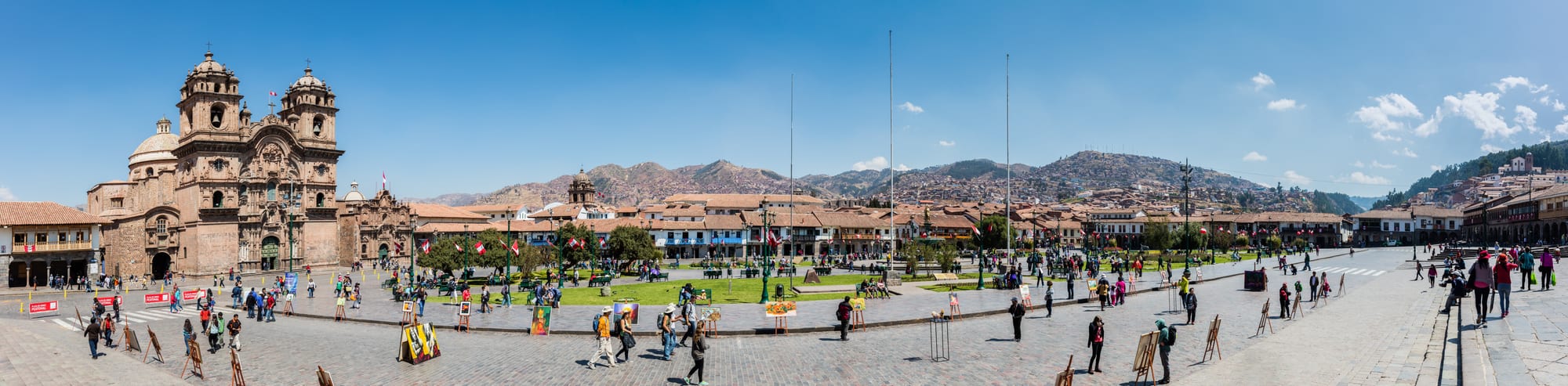 A grand colonial plaza with a cathedral and arcaded buildings