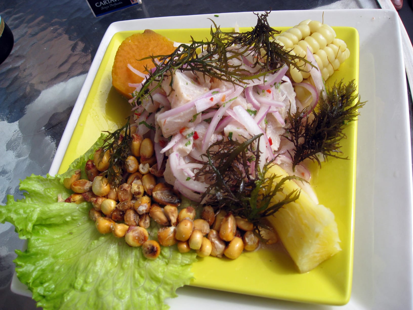 A plate of raw fish cured in citrus with corn and sweet potato