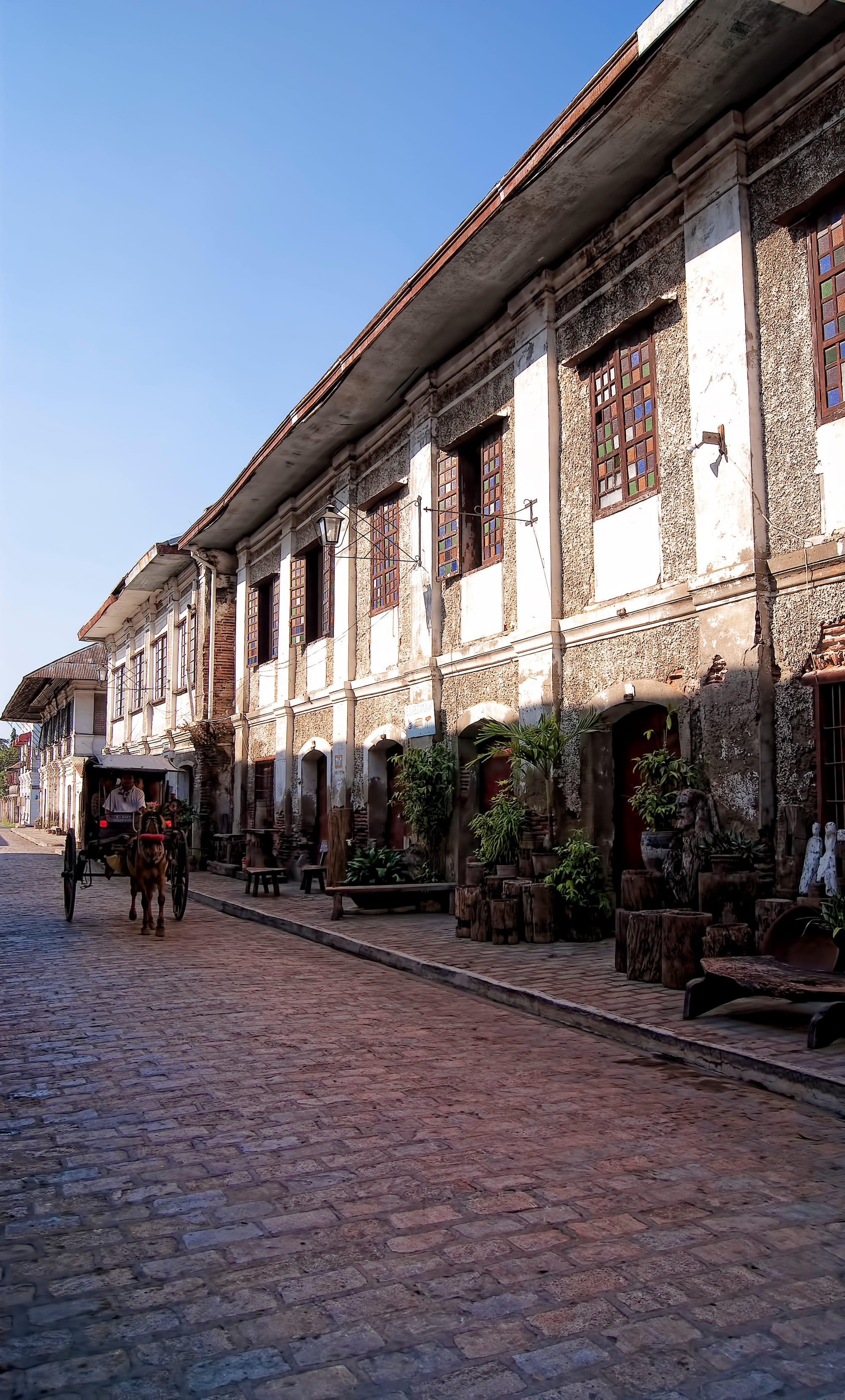 A cobblestone street lined with Spanish colonial-era buildings