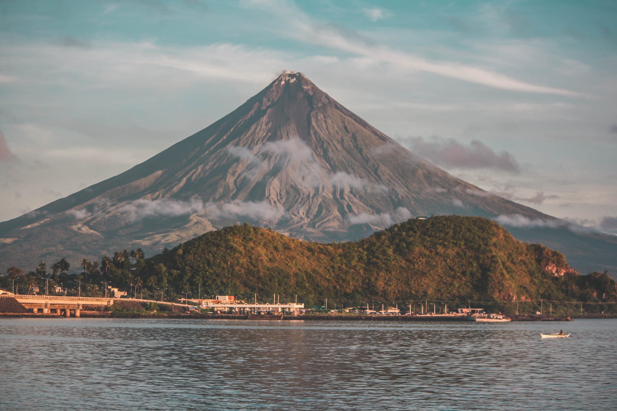 A perfectly cone-shaped volcano rising above the landscape