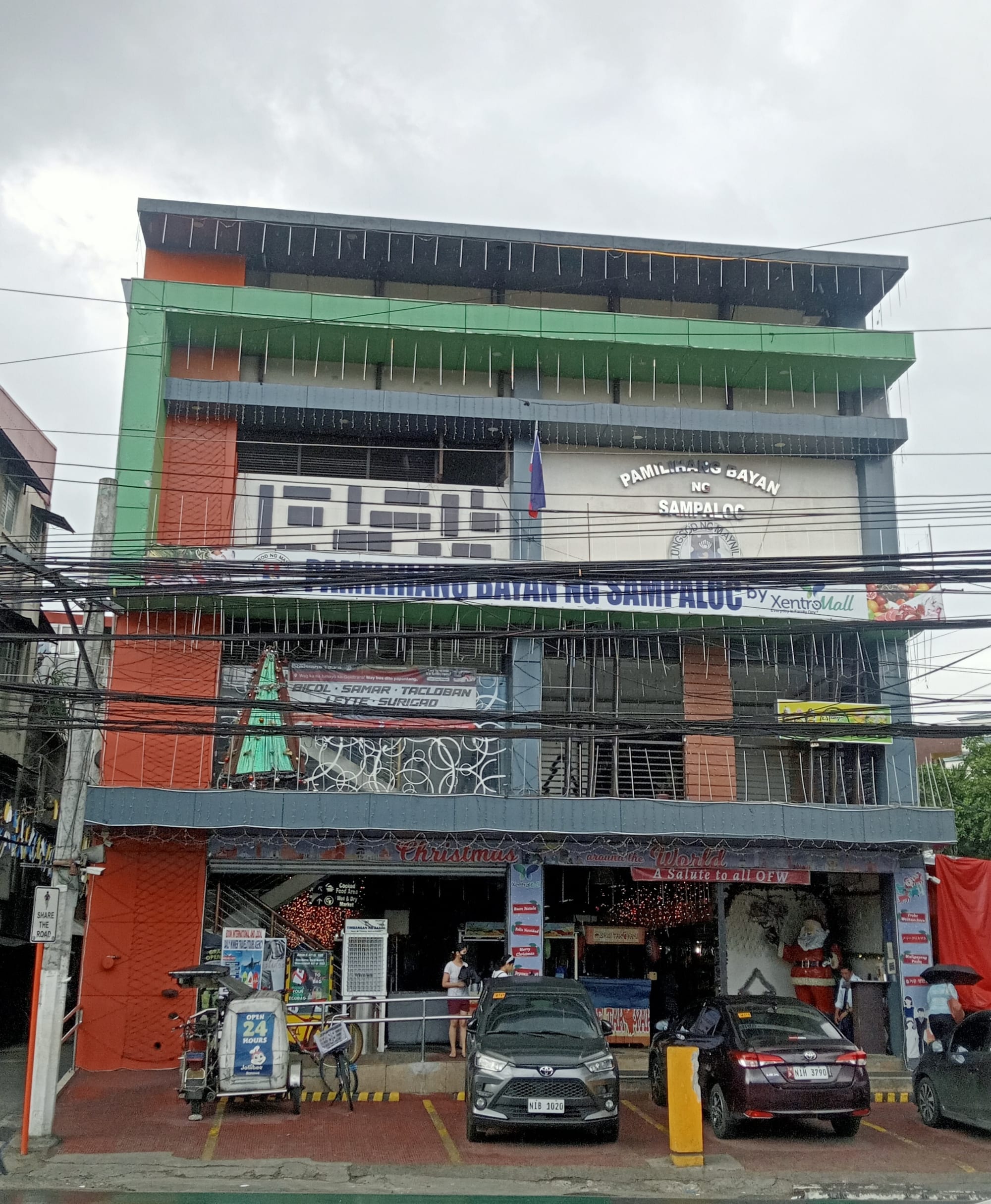 An indoor public market with produce and food stalls