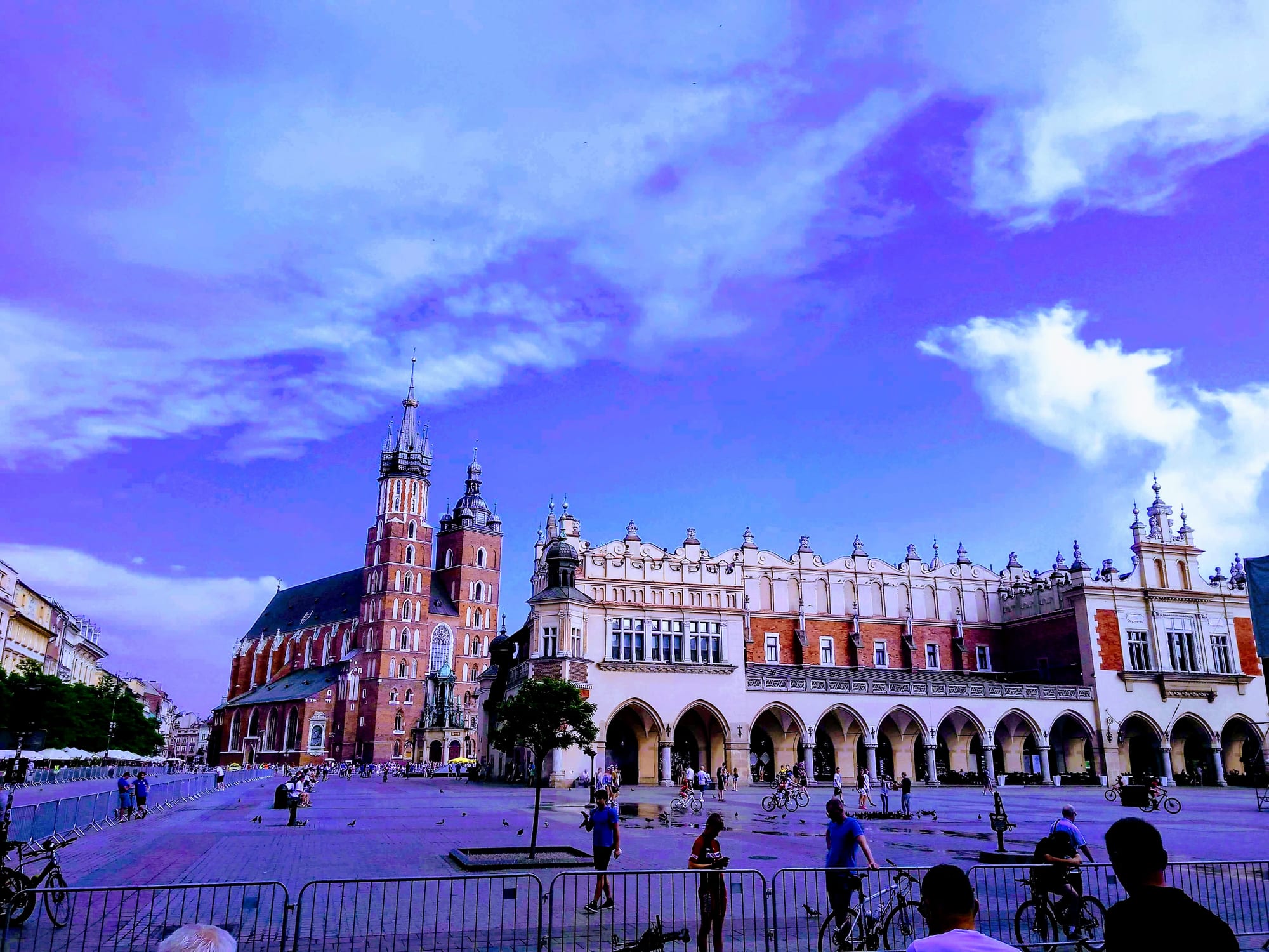 A grand medieval market square with a long Renaissance market hall
