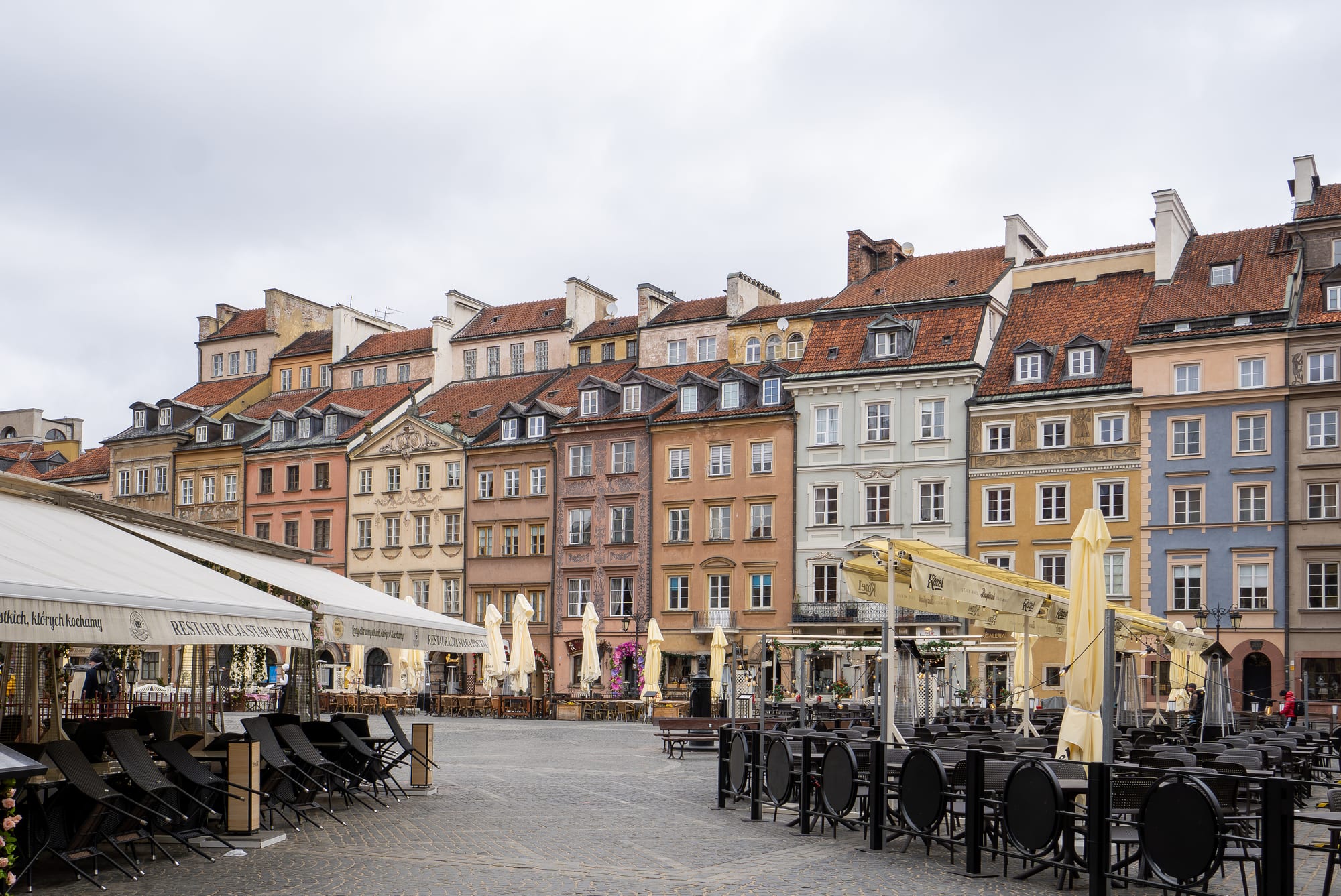 A colourful market square lined with narrow historic townhouses
