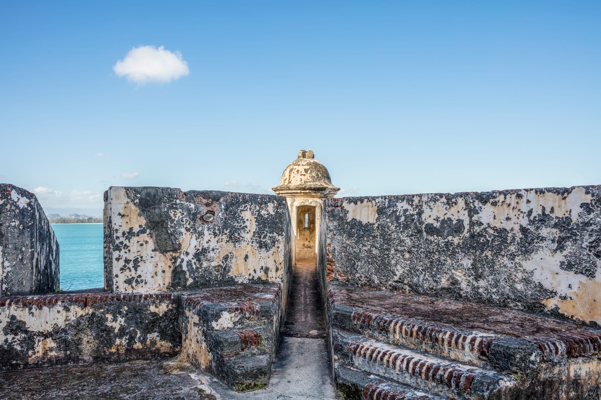 A massive stone fortress on a headland overlooking the ocean