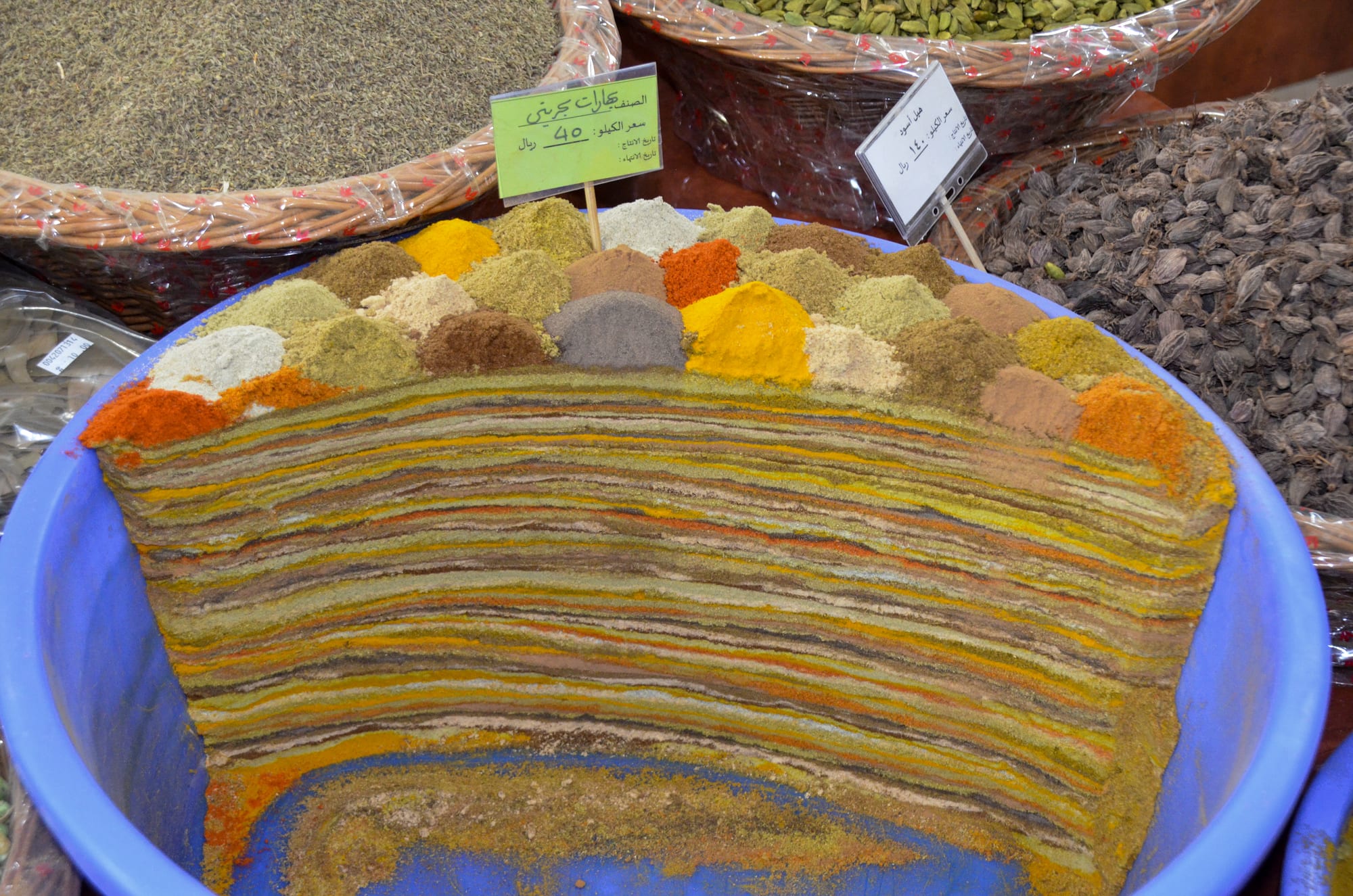Colourful layered spices displayed for sale at a market stall