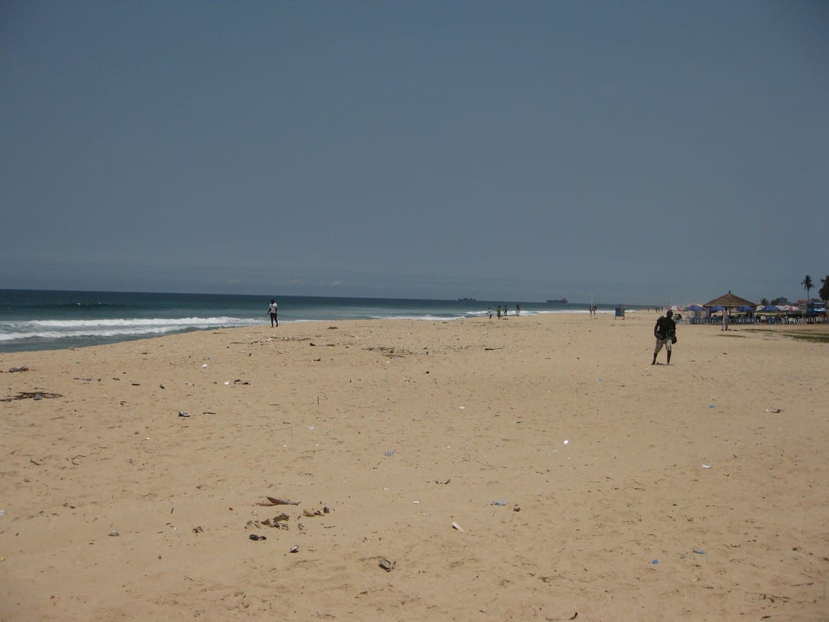 A wide sandy Atlantic beach with palm trees