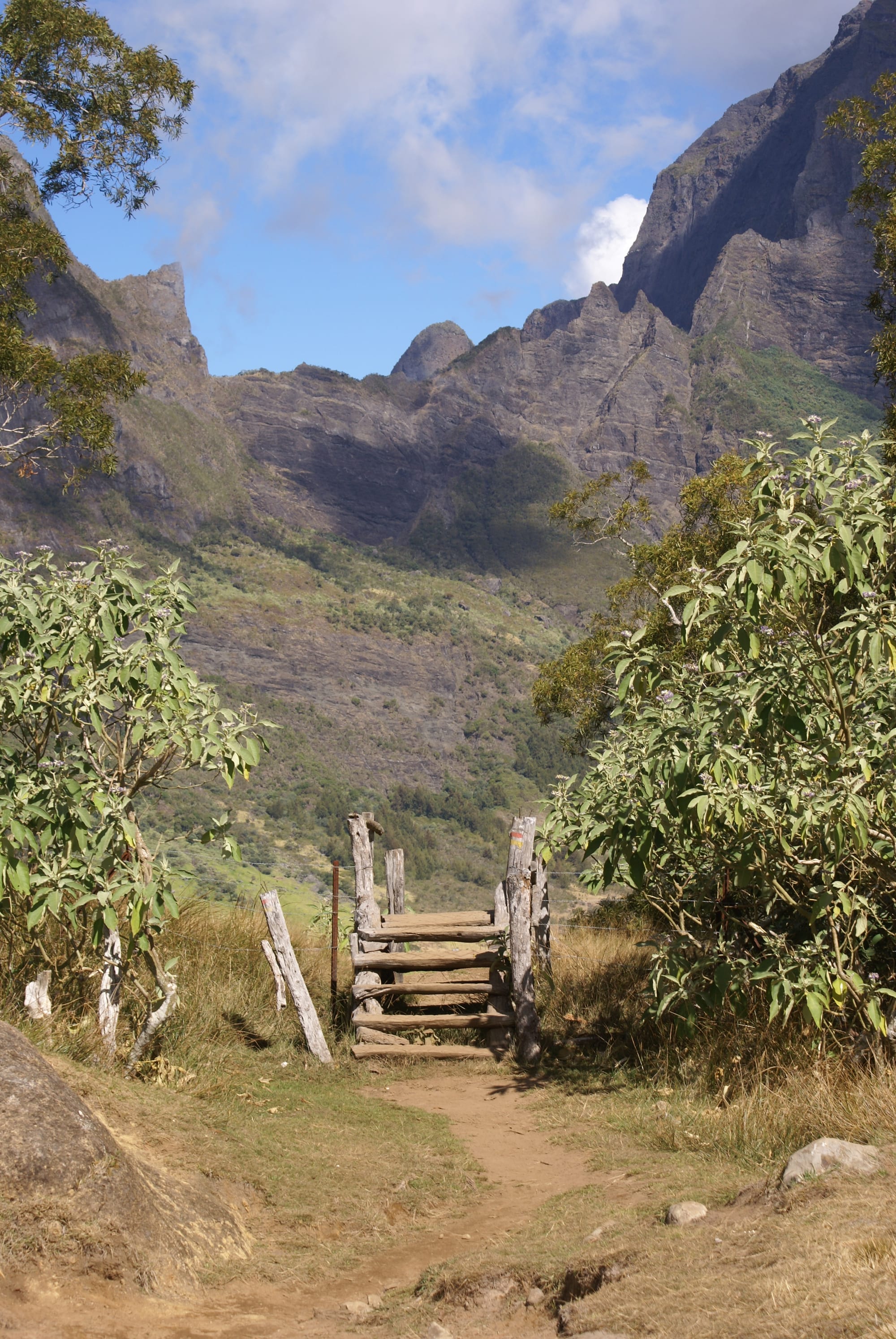 A remote mountain village surrounded by steep cliffs and green ridges