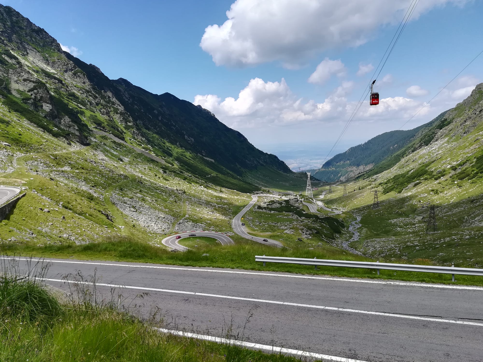 A winding mountain road with sharp switchbacks climbing through the Carpathians