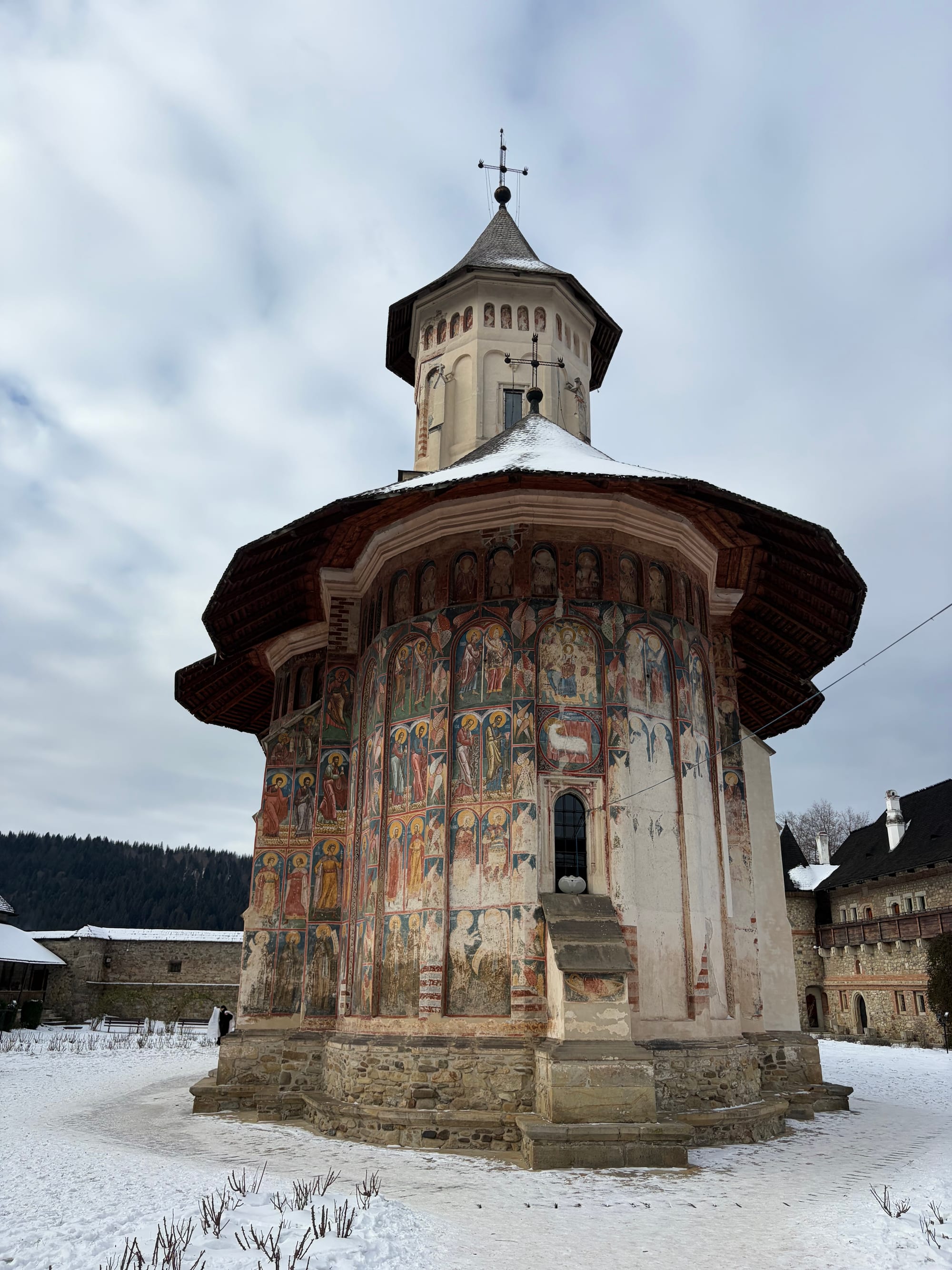 A monastery church covered in colourful painted religious frescoes