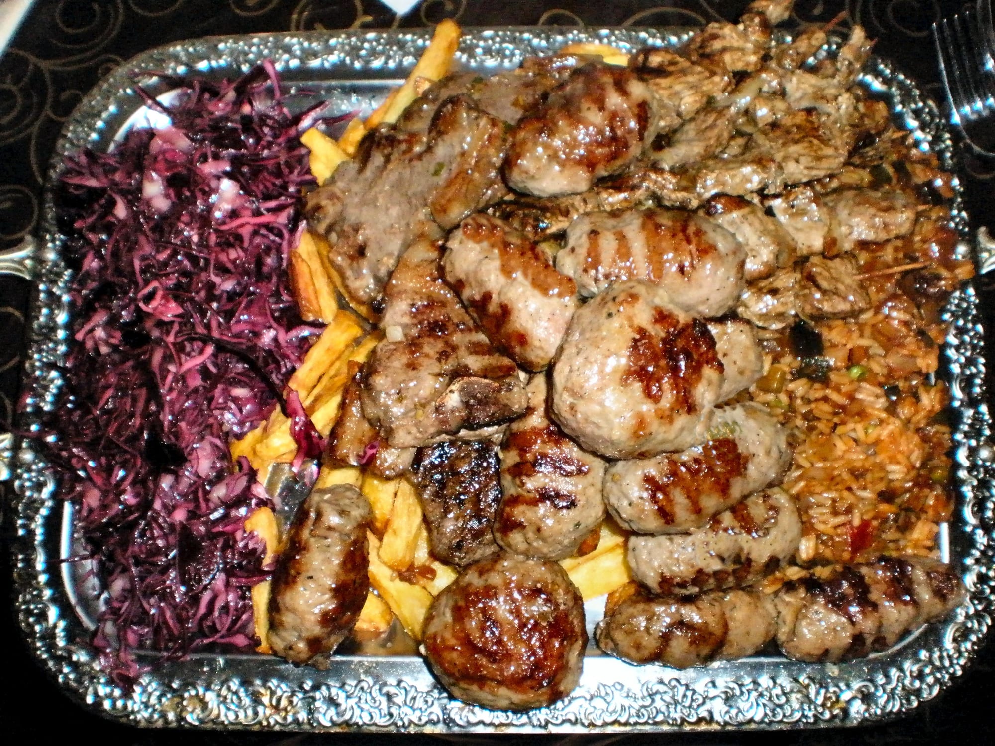 Grilled meat rolls served with side dishes