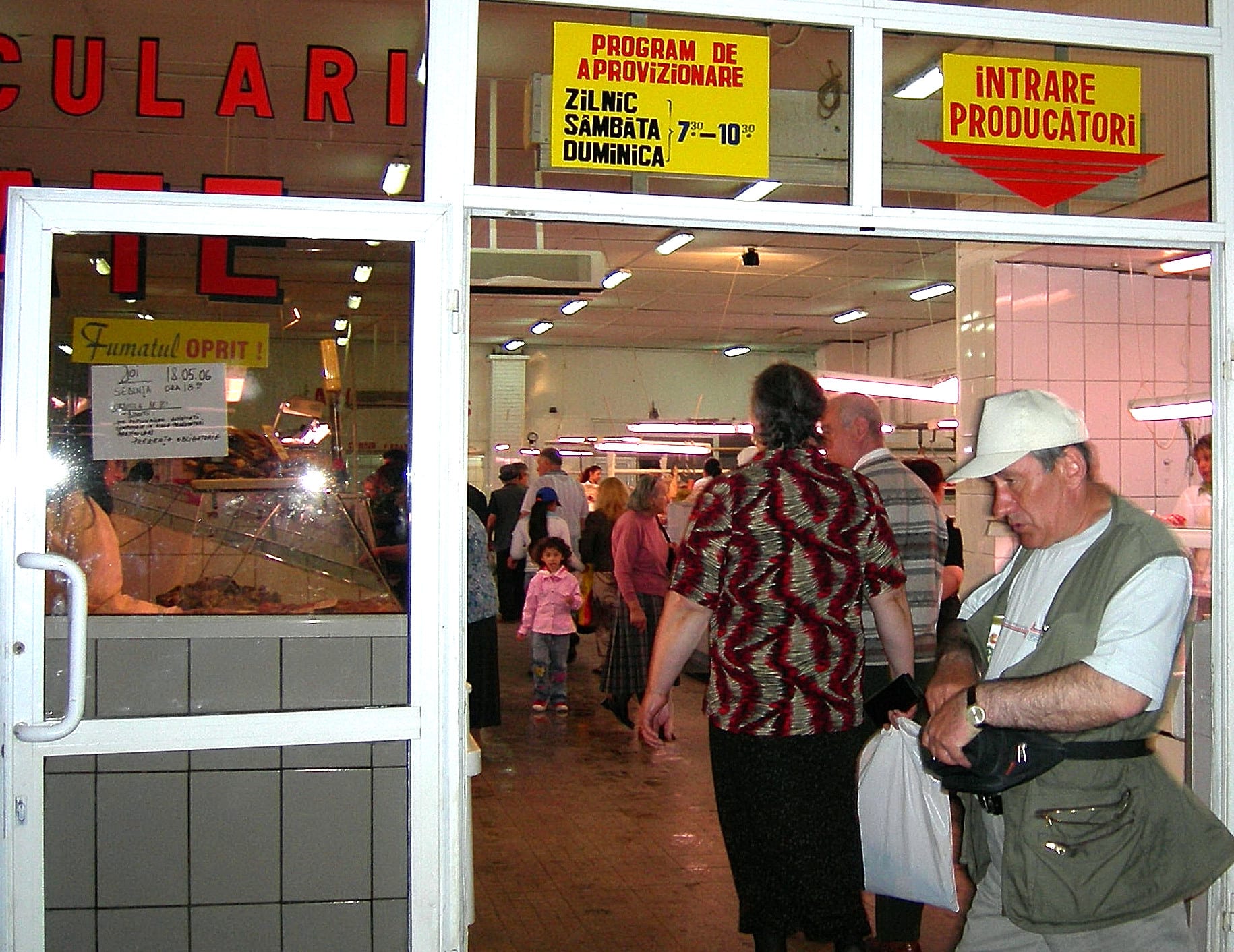 An outdoor produce market with vendors and stalls