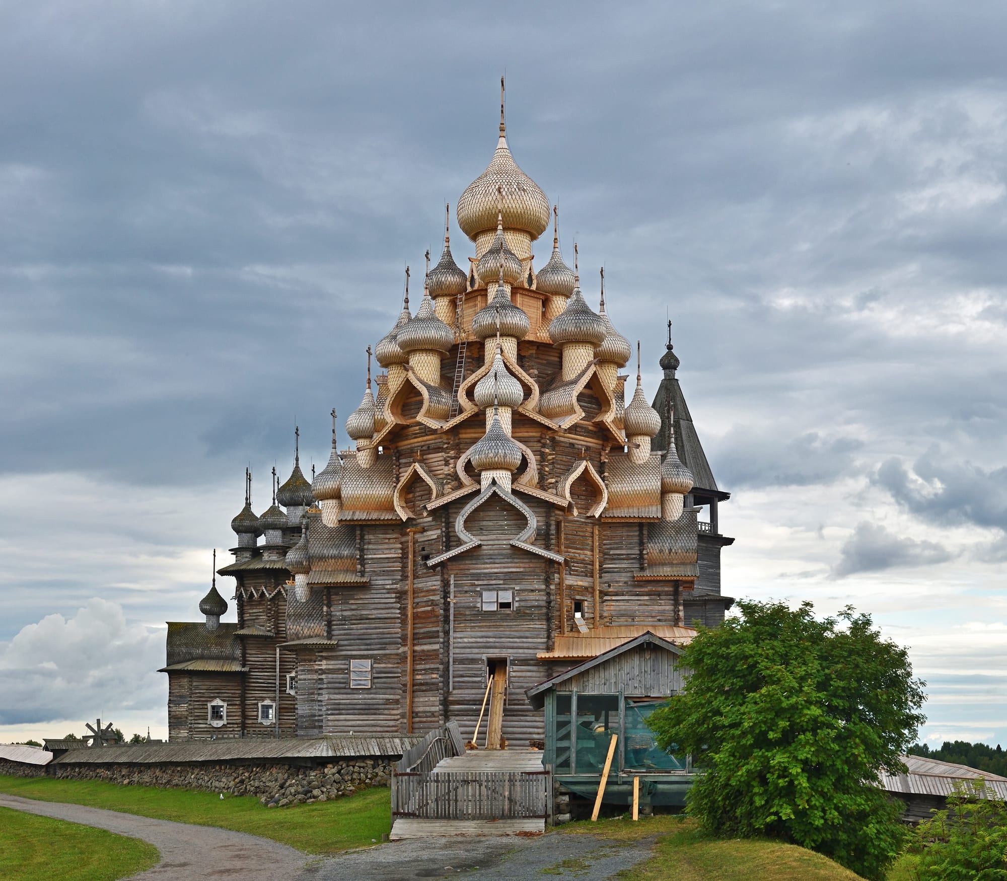 An elaborate wooden church with many small domes stacked in tiers
