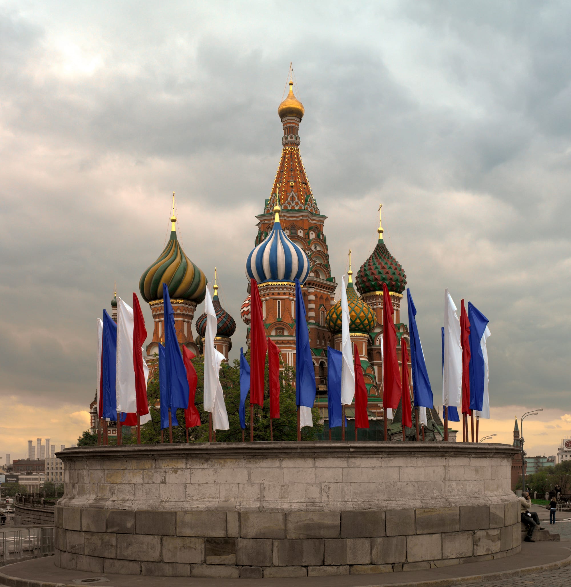 A colourful cathedral with multiple onion-shaped domes on a city square