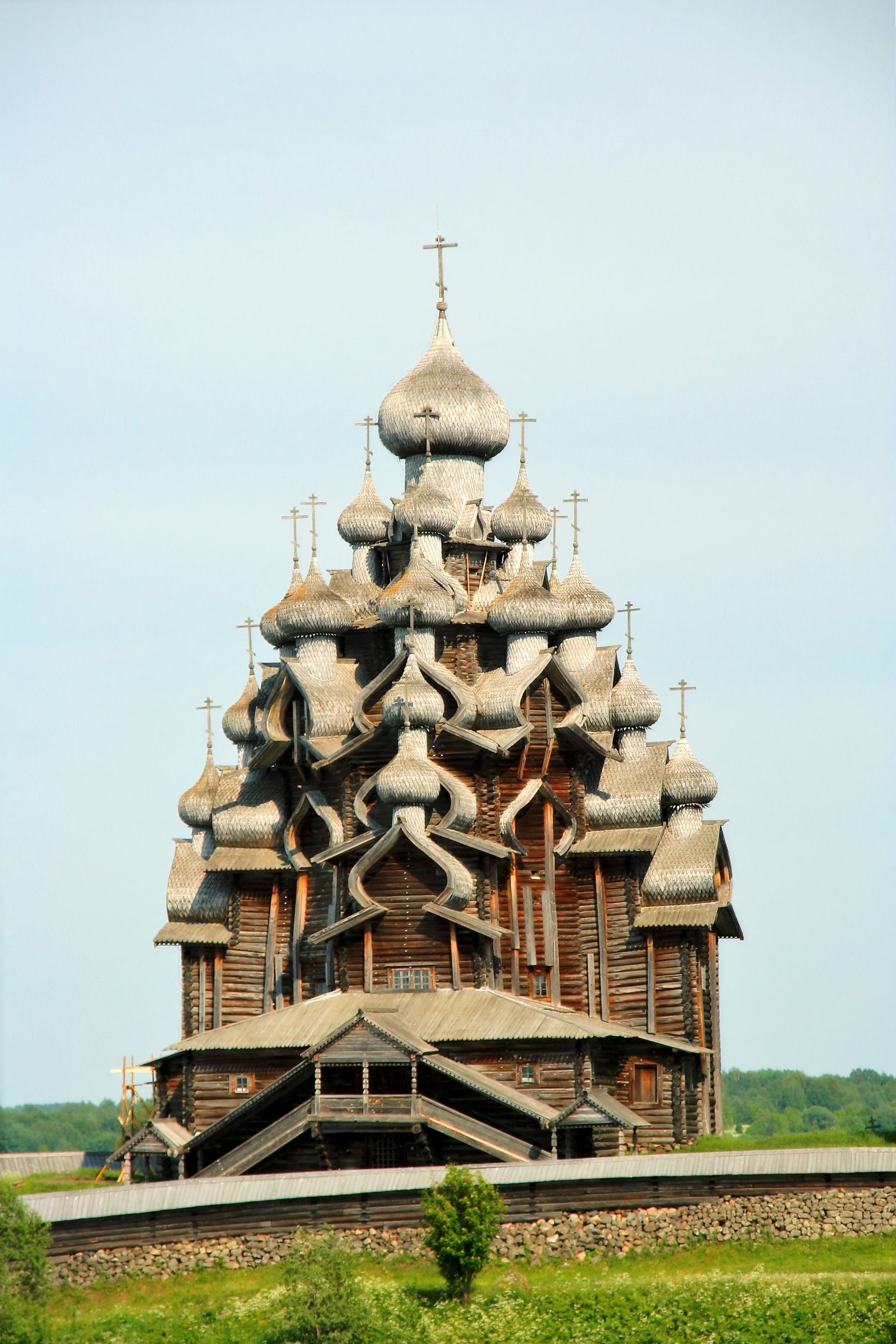 A towering wooden church crowded with silvery shingled domes at Kizhi in northern Russia