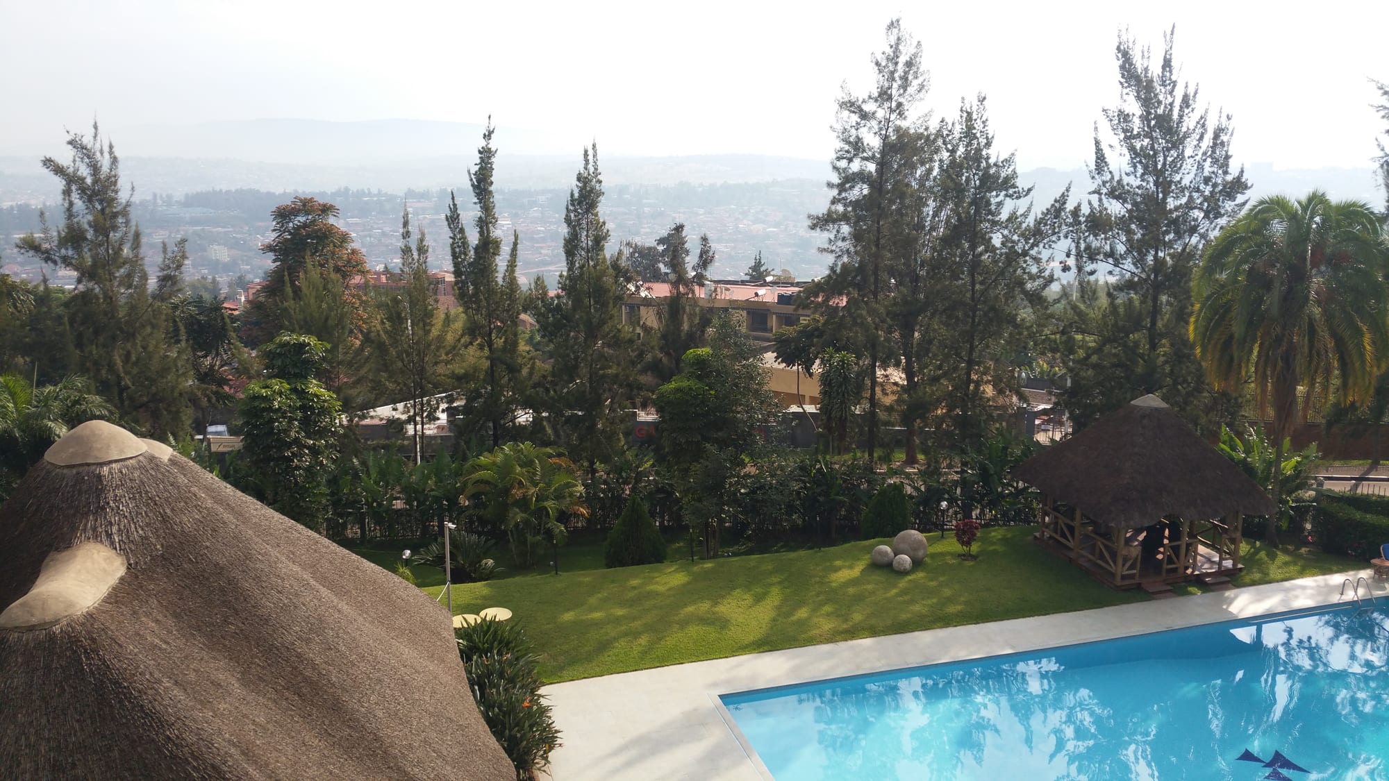 A view over Kigali's hills and low-rise buildings from a terrace