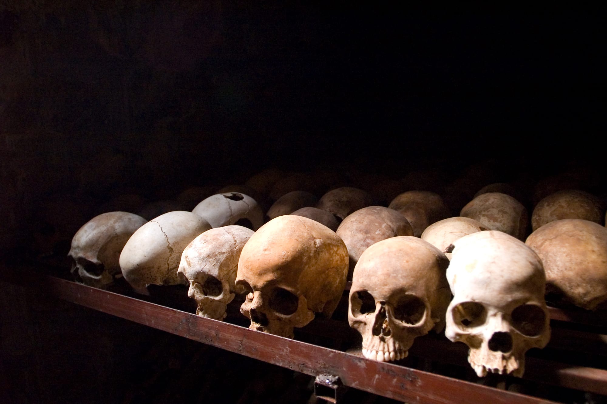 Rows of victims' clothing laid over church pews inside the Nyamata genocide memorial