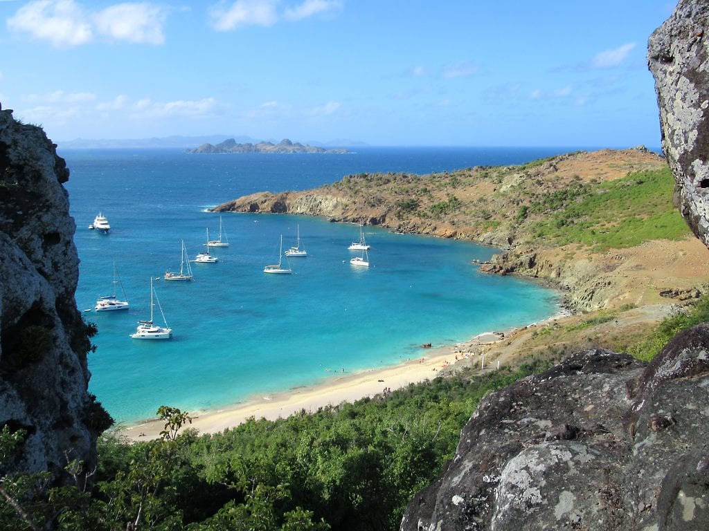 A secluded beach cove accessible only by boat or a coastal trail