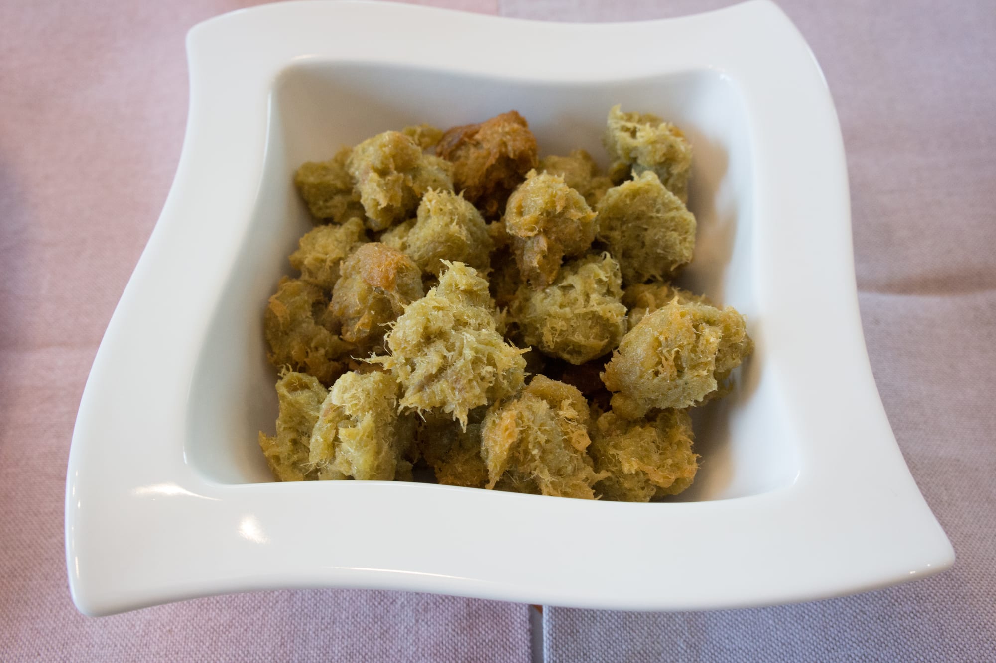 A bowl of fried saltfish fritters