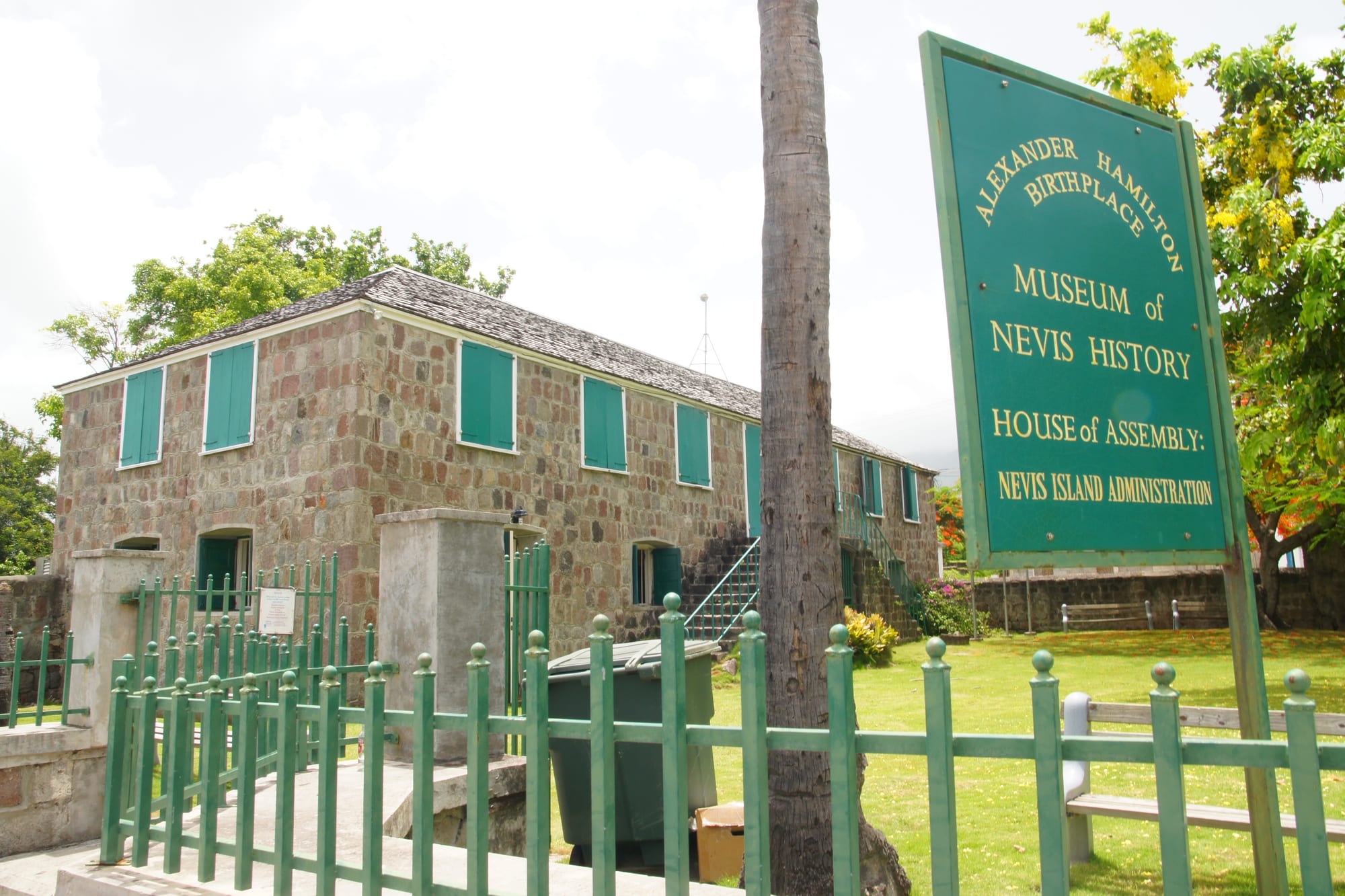 A restored two-storey stone Georgian house with a veranda, the Museum of Nevis History, in Charlestown