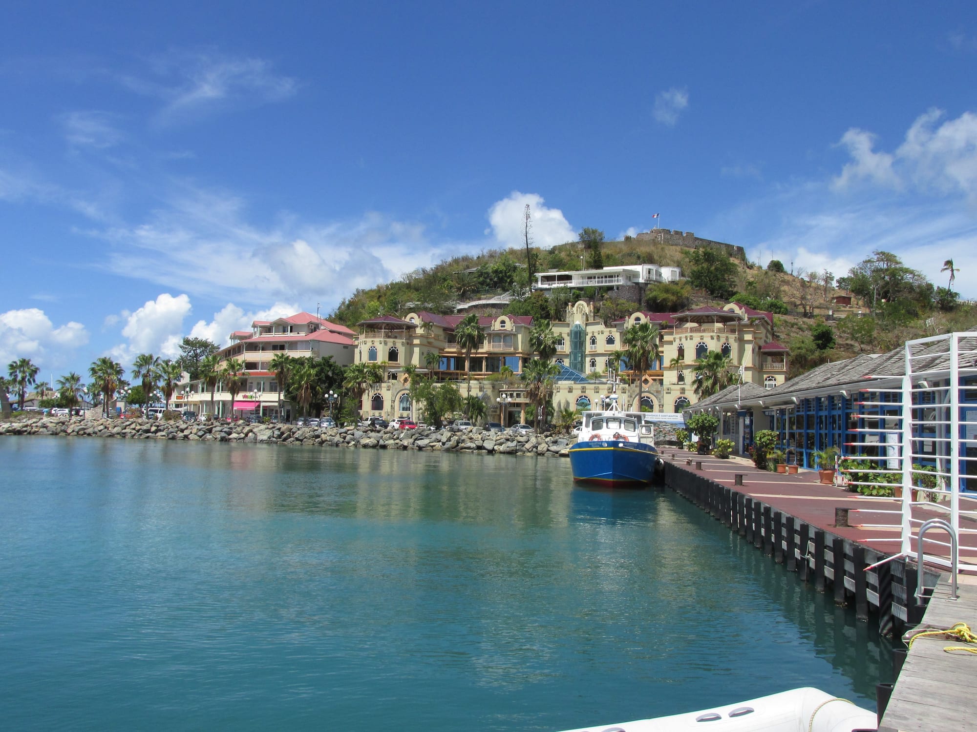 A harbourfront town with markets and colourful buildings along the water