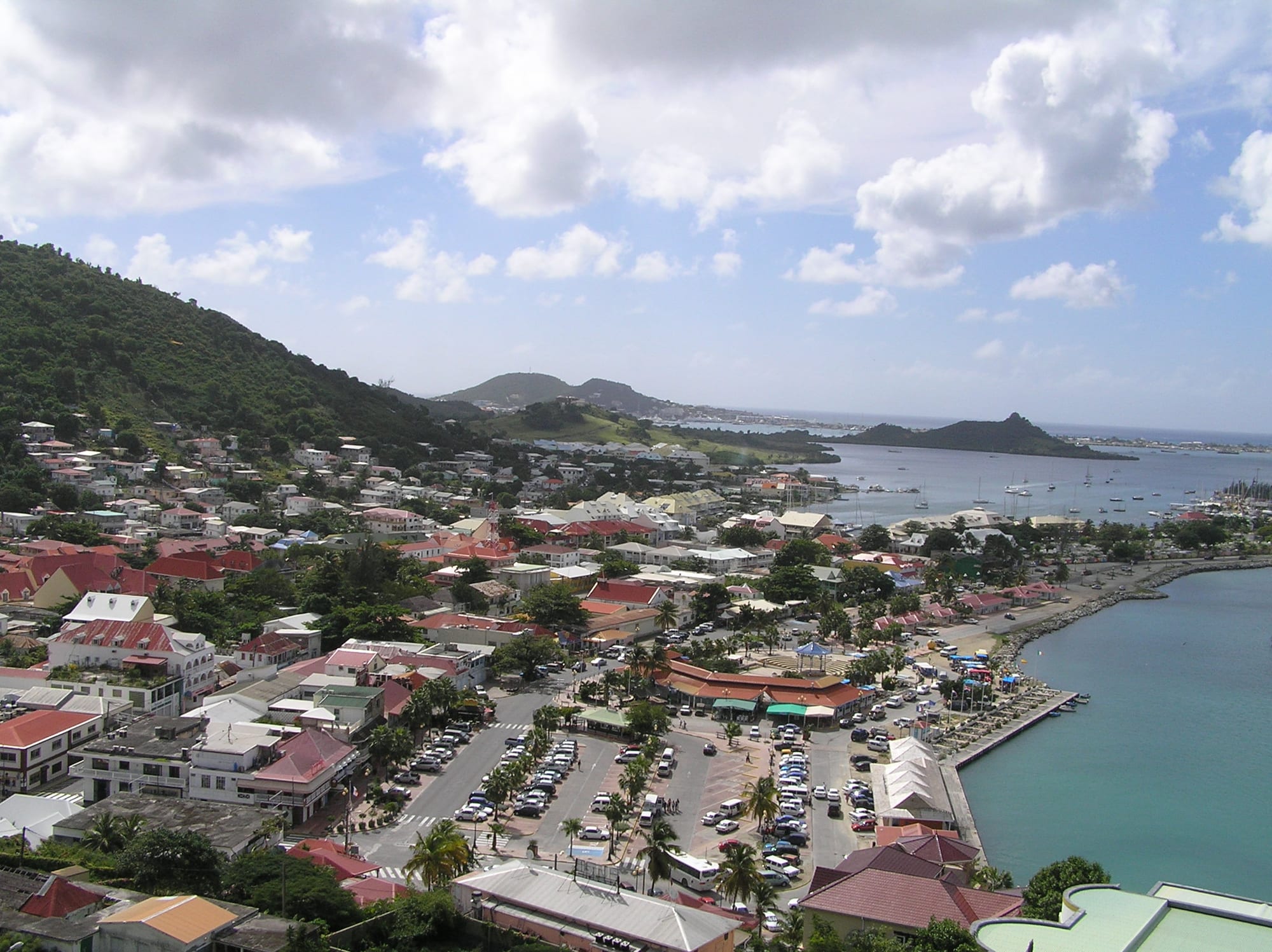 A harbour town with a hillside fort overlooking colourful waterfront buildings