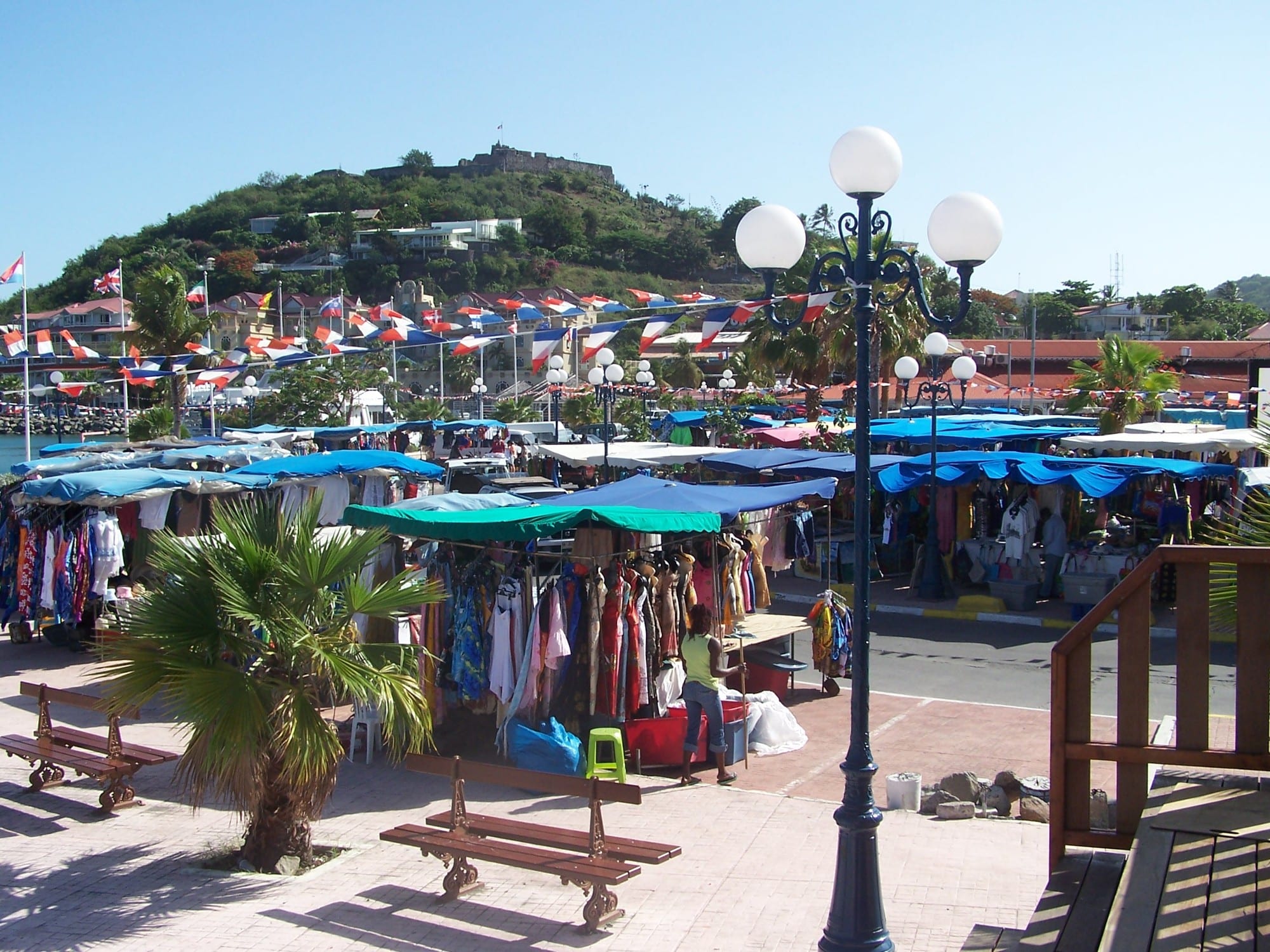 An outdoor market with produce and goods for sale