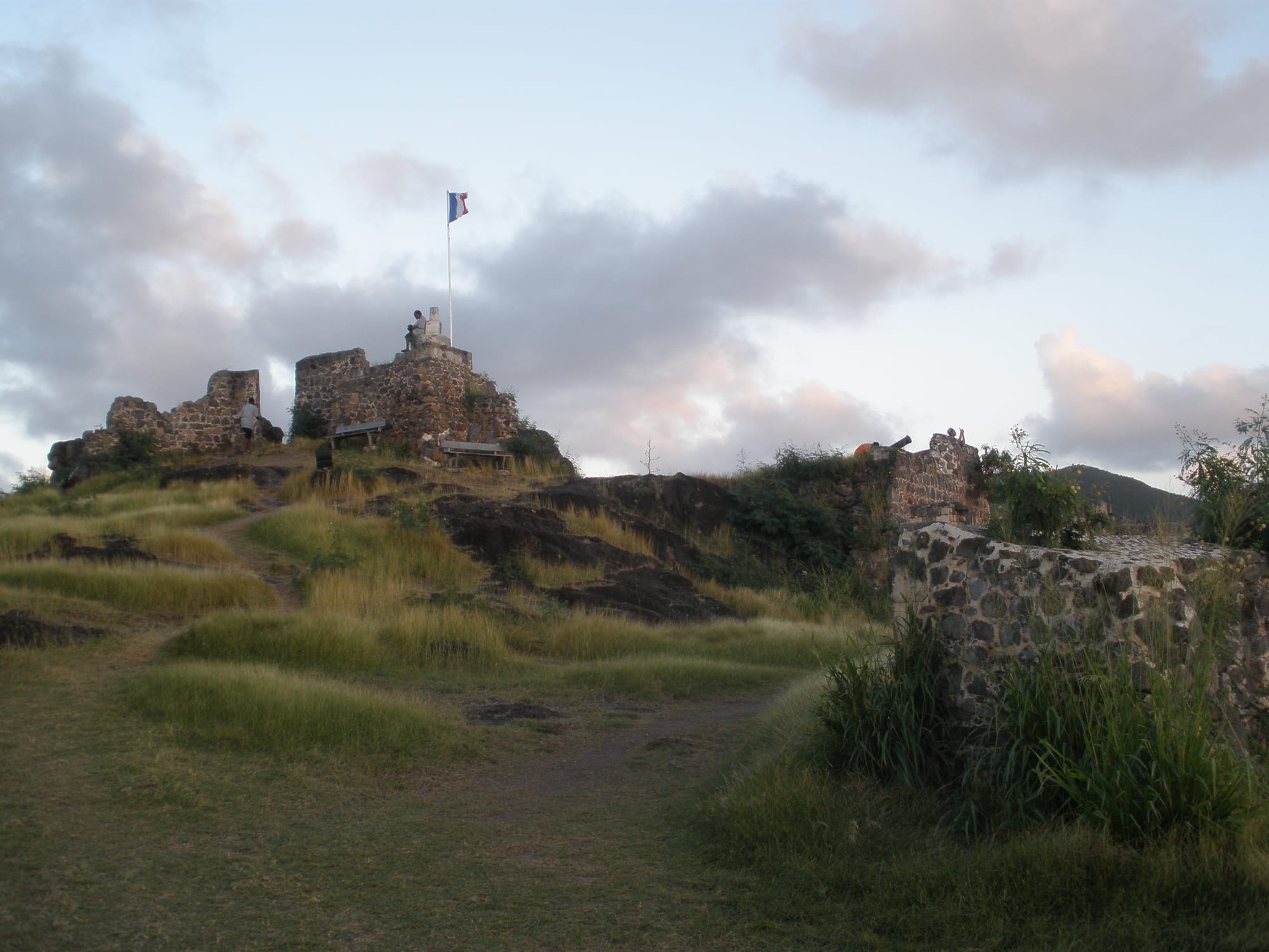 The low stone ruins of Fort Louis on a hilltop overlooking Marigot's bay and marina