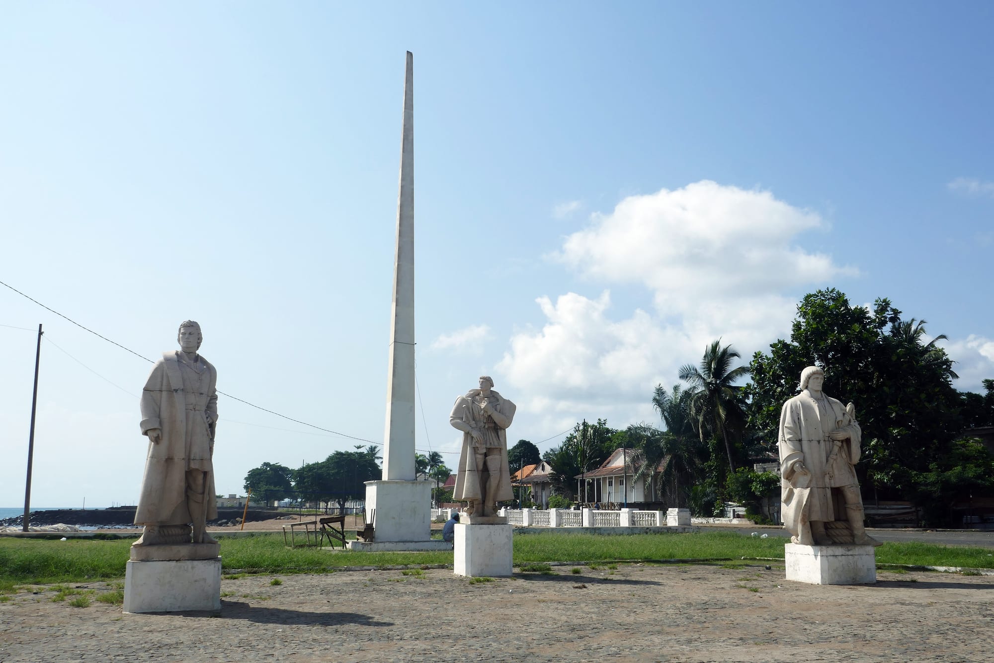 Statues of historical explorers displayed within an old fort courtyard