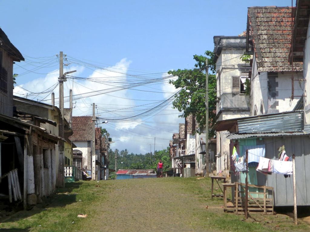 Old colonial-era plantation buildings in a state of gentle decay