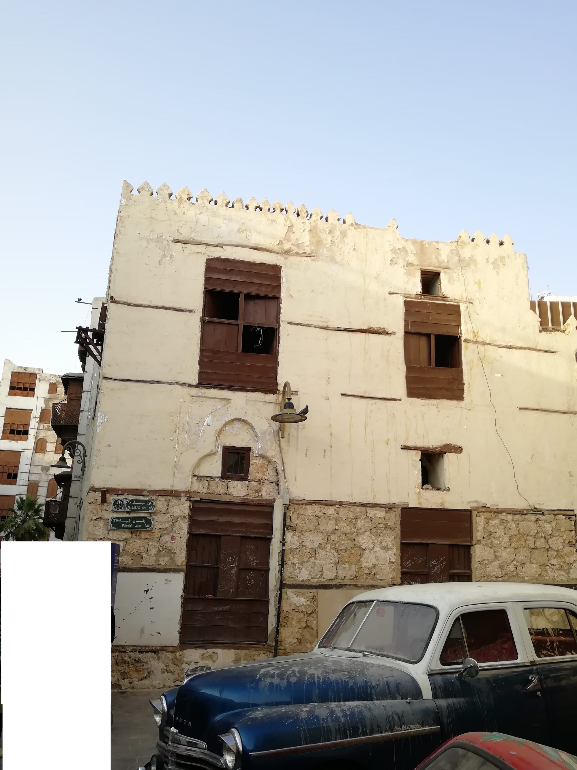 Traditional multi-storey coral-stone buildings with ornate wooden latticed windows